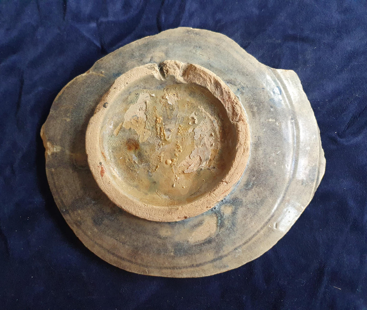 A rare, large shard from a plate, featuring a depiction on the base of a striding putto with a bow . 17th