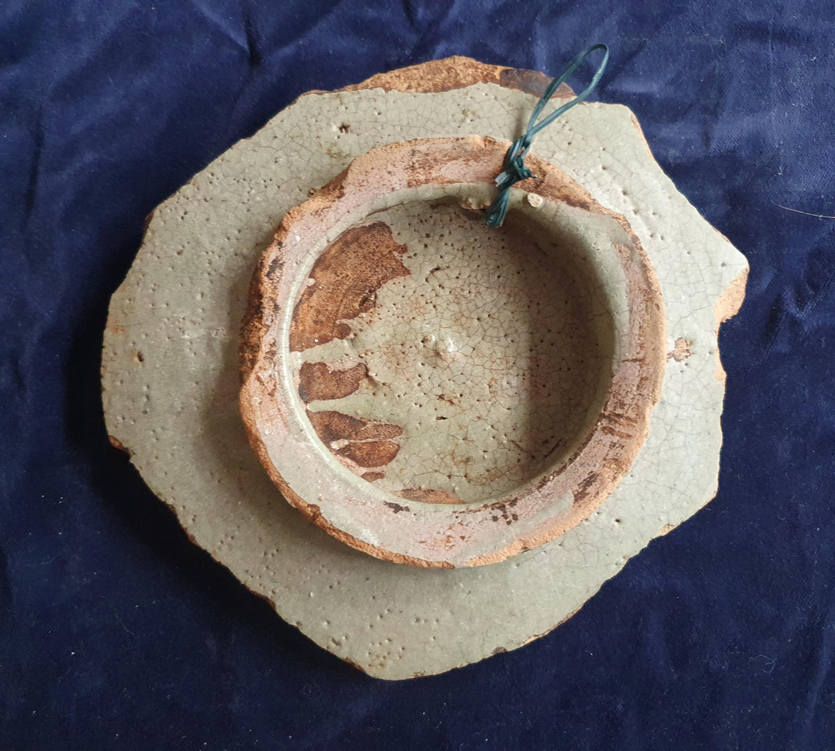 A rare, large shard from a plate, featuring a depiction on the base of a striding putto with a flower. 17th.