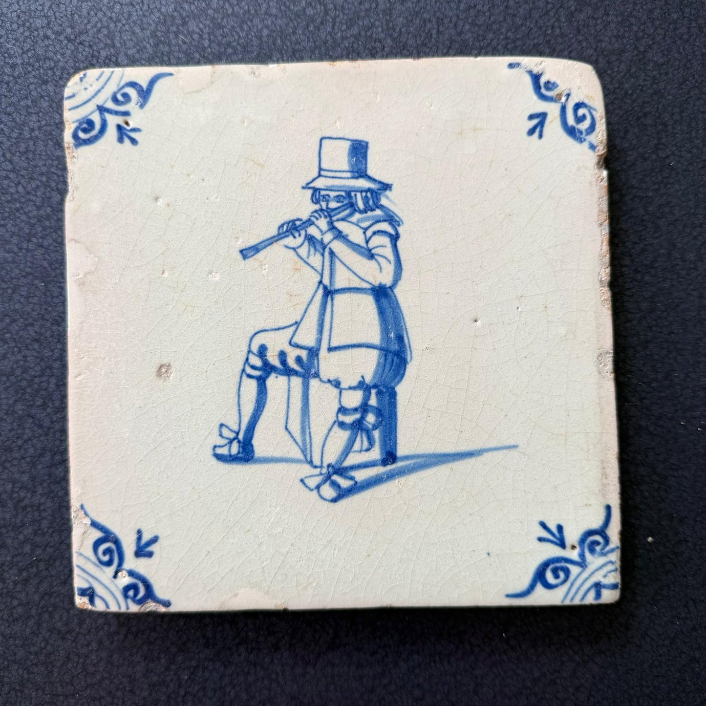 Dutch Delft Tile man playing the flute