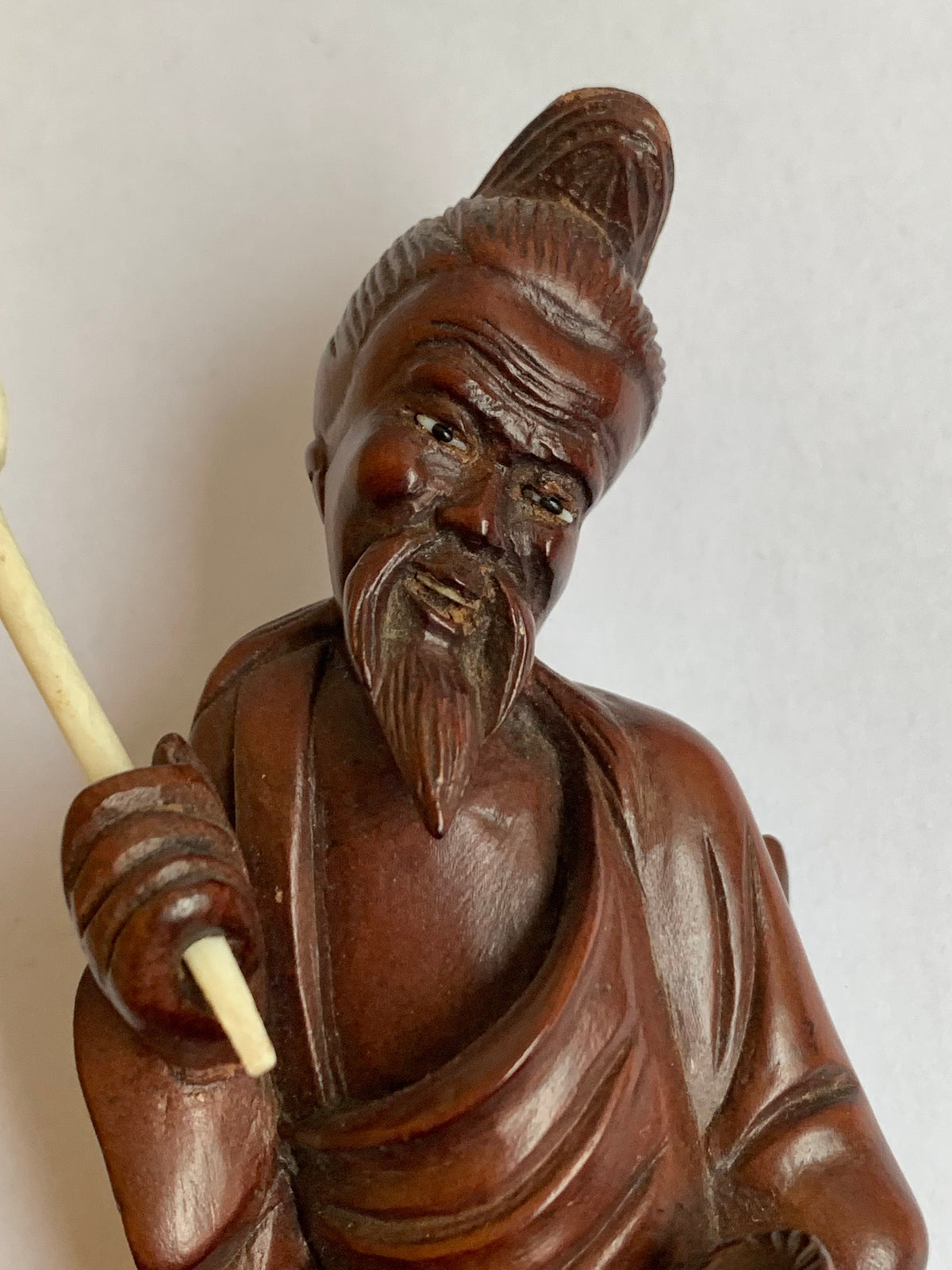 Hand-carved wooden statue of a fisherman - porcelain, early 20th century
