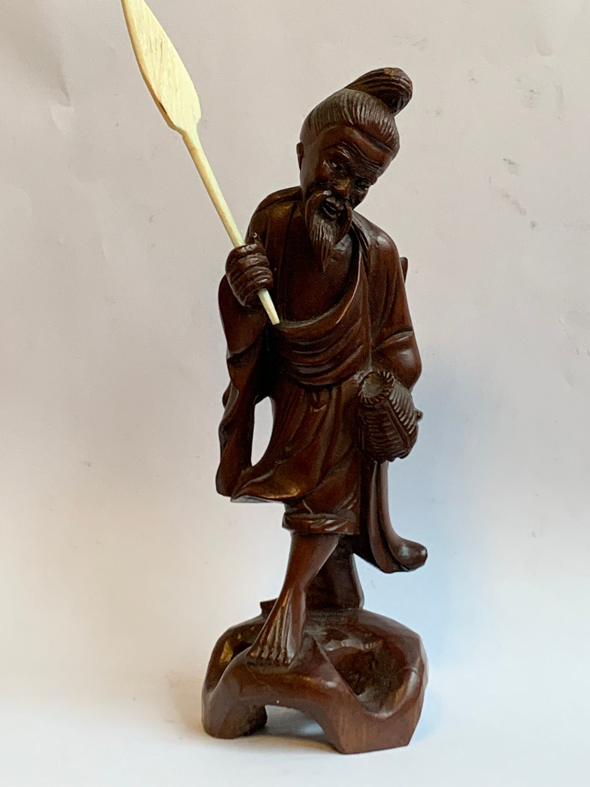 Hand-carved wooden statue of a fisherman - porcelain, early 20th century