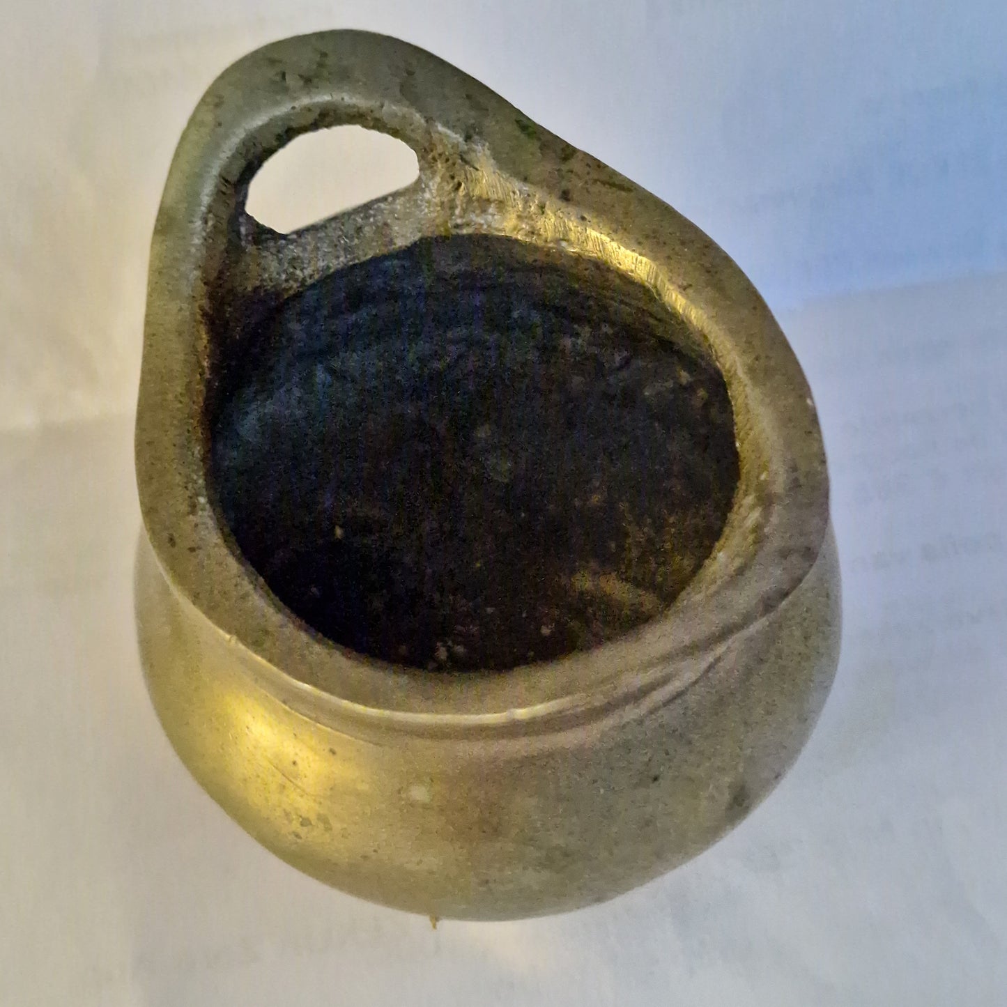 A Chinese bronze tripod censer, of typical shallow rounded form, supported on three short legs, the base with an apocryphal character mark