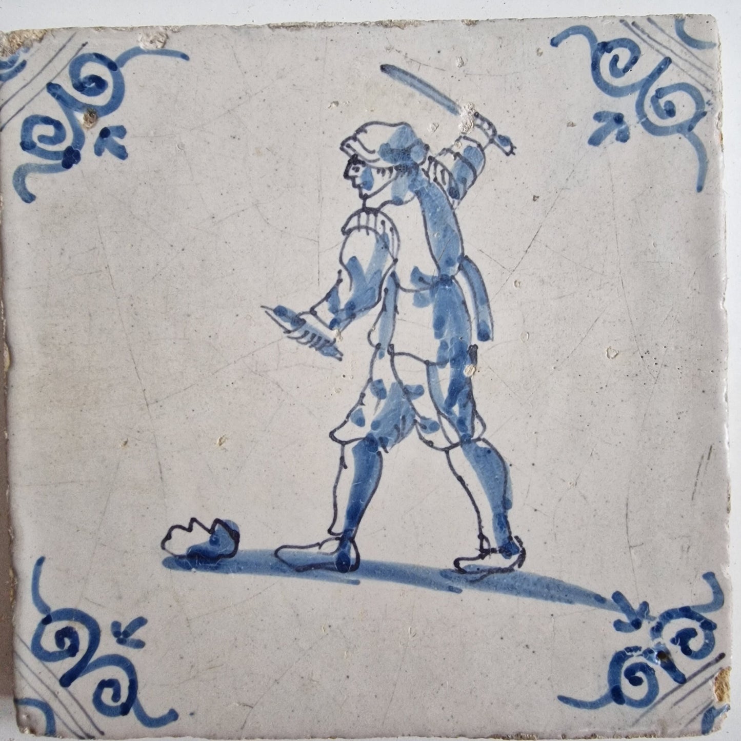 Antique Dutch Tile - man with knife  - Dated 1640, oxhead corner