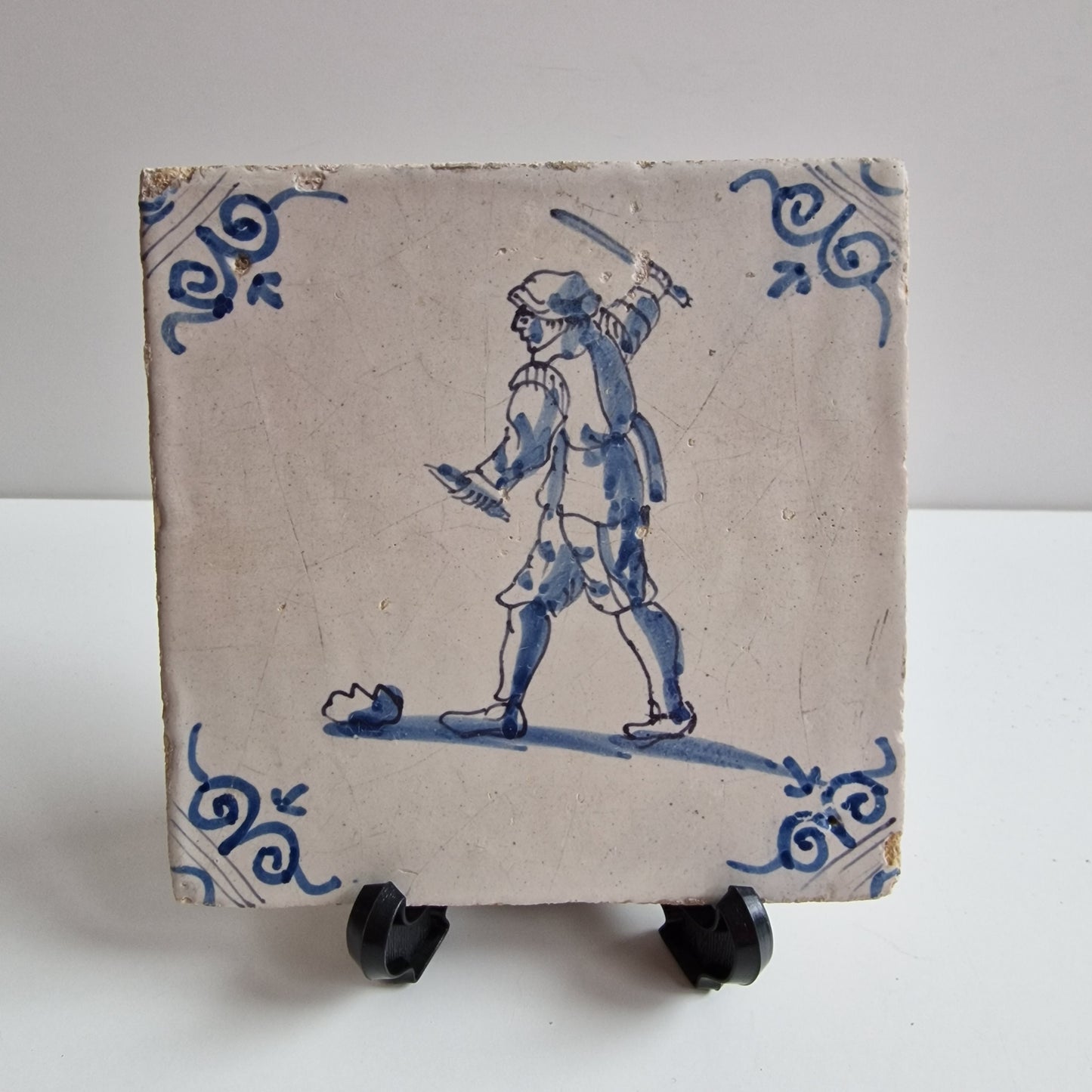 Antique Dutch Tile - man with knife  - Dated 1640, oxhead corner