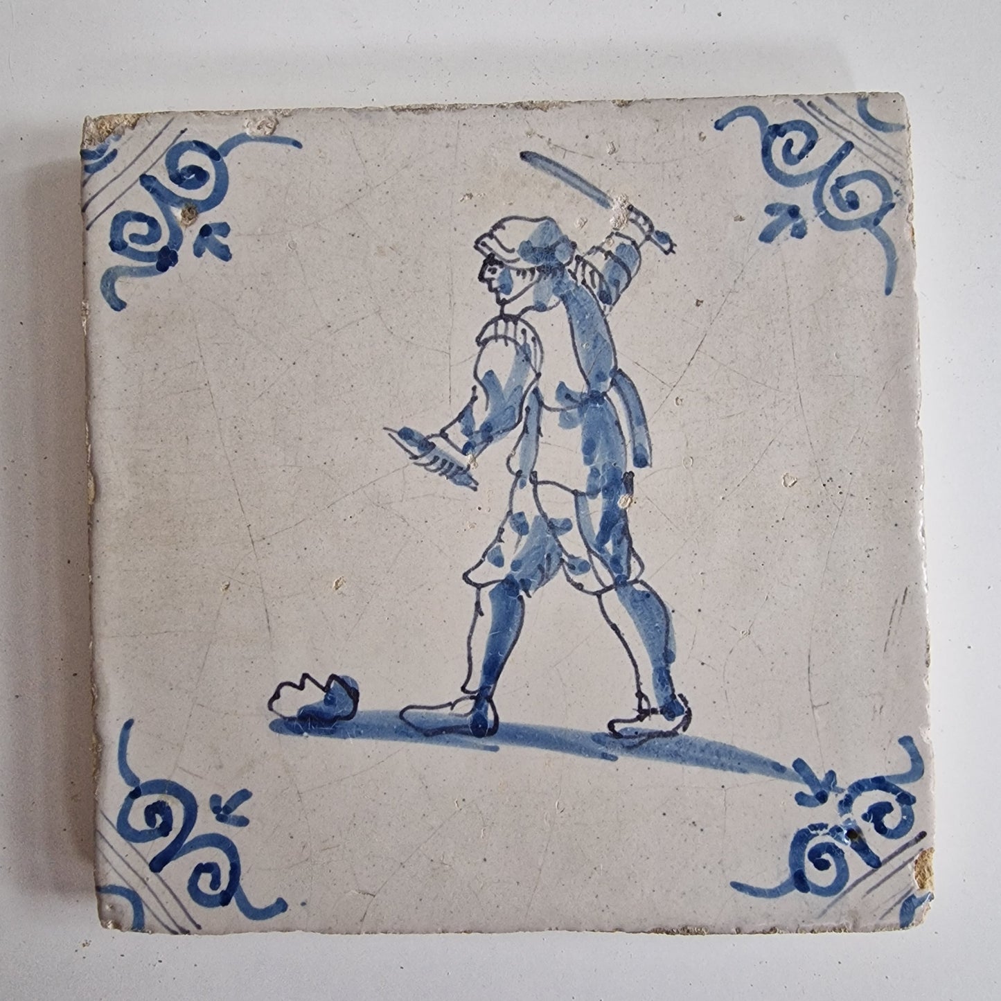 Antique Dutch Tile - man with knife  - Dated 1640, oxhead corner