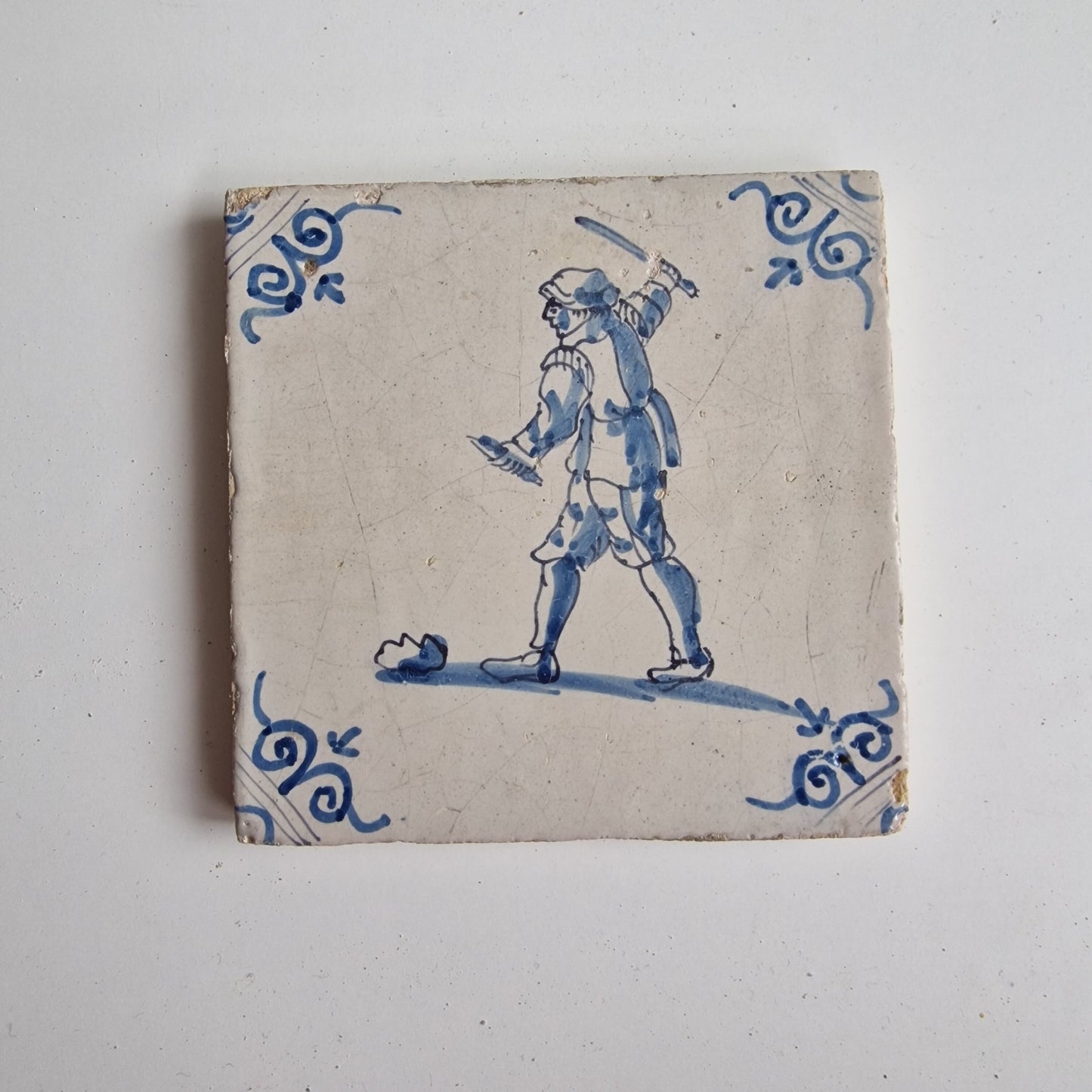 Antique Dutch Tile - man with knife  - Dated 1640, oxhead corner