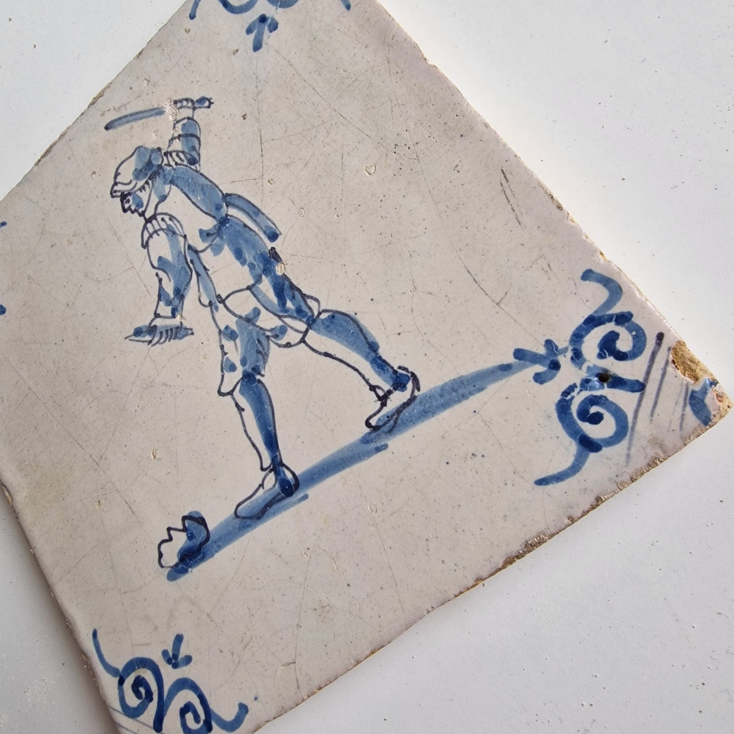 Antique Dutch Tile - man with knife  - Dated 1640, oxhead corner