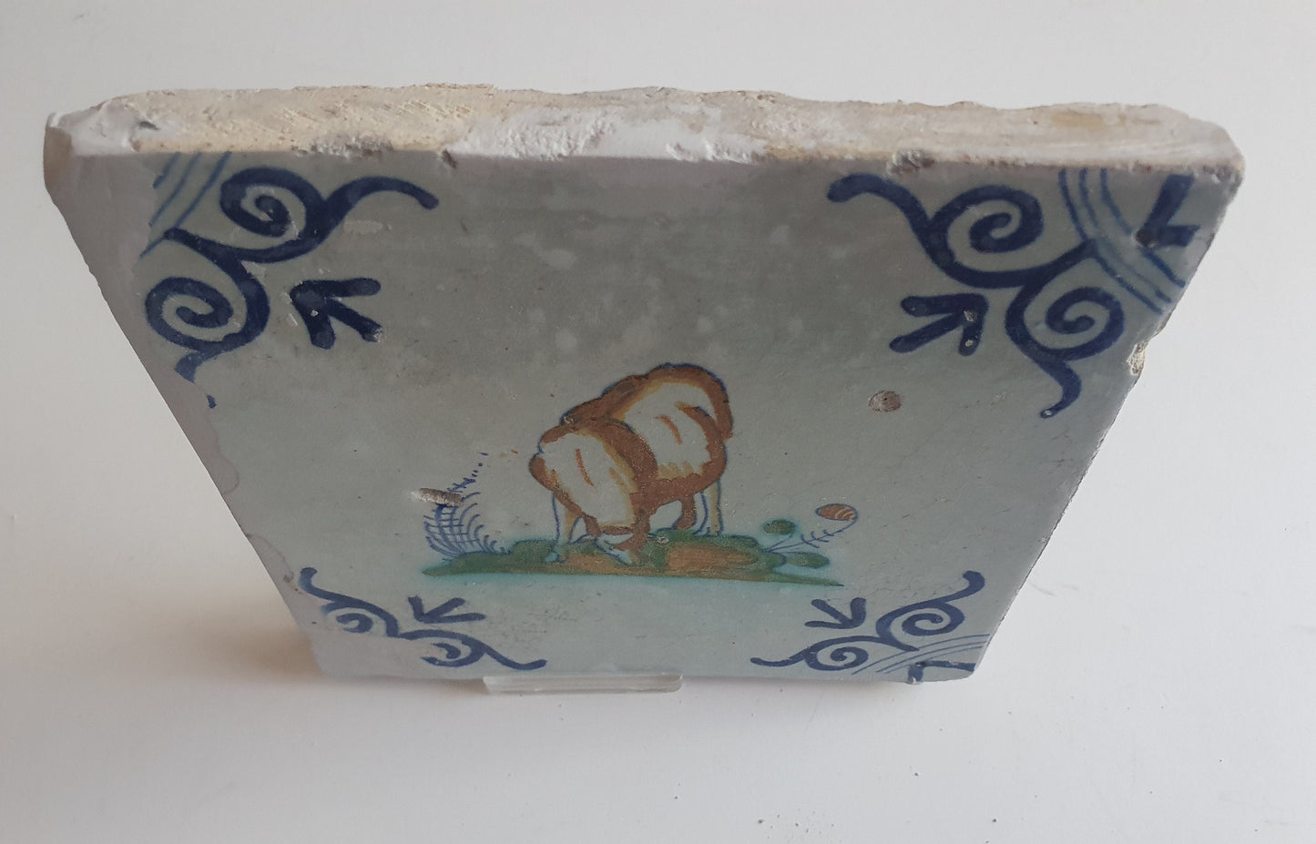 Antique Dutch Delft Tile – Sheep Motif, Polychrome Oxhead Corner, 17th Century