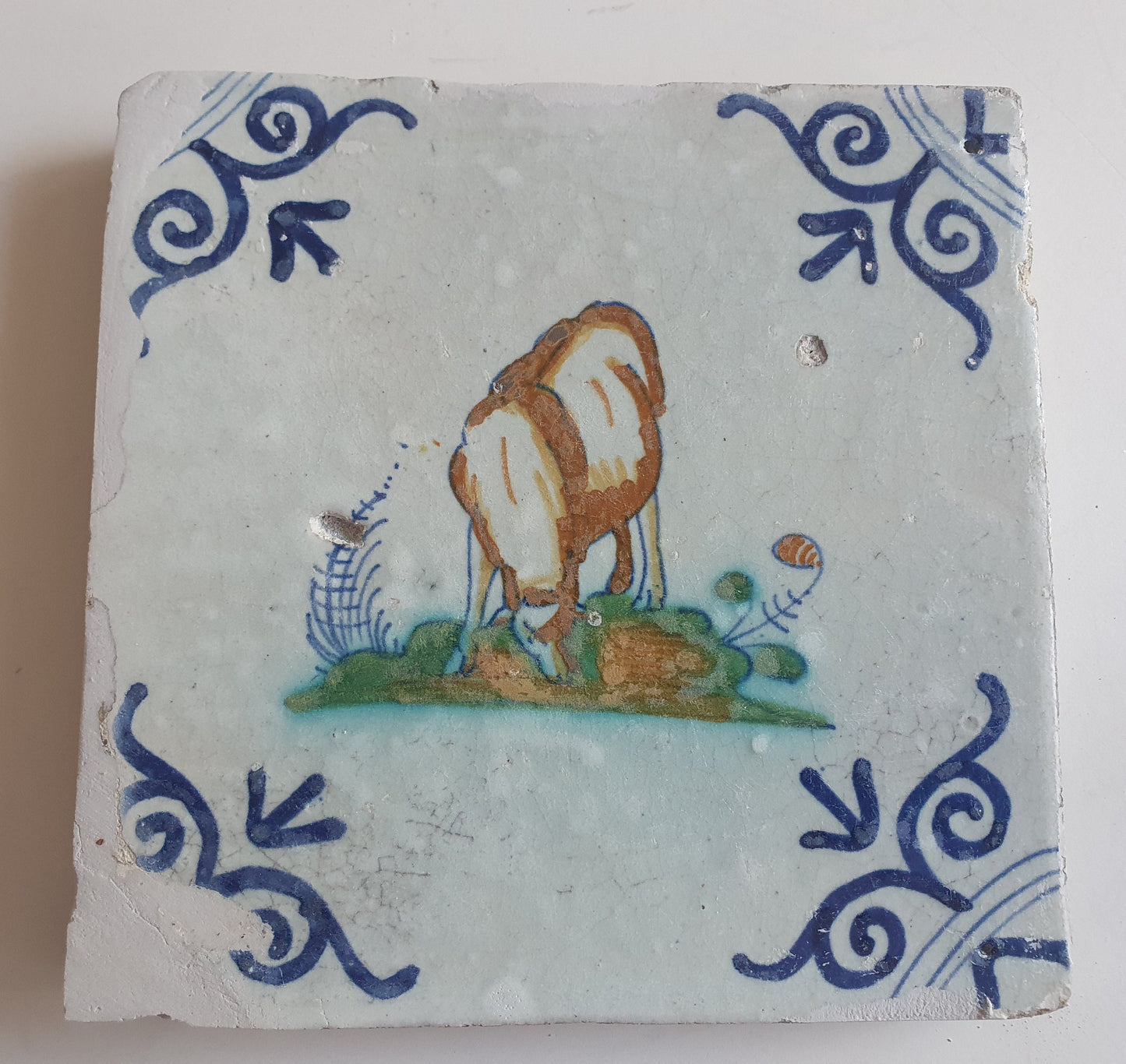 Antique Dutch Delft Tile – Sheep Motif, Polychrome Oxhead Corner, 17th Century