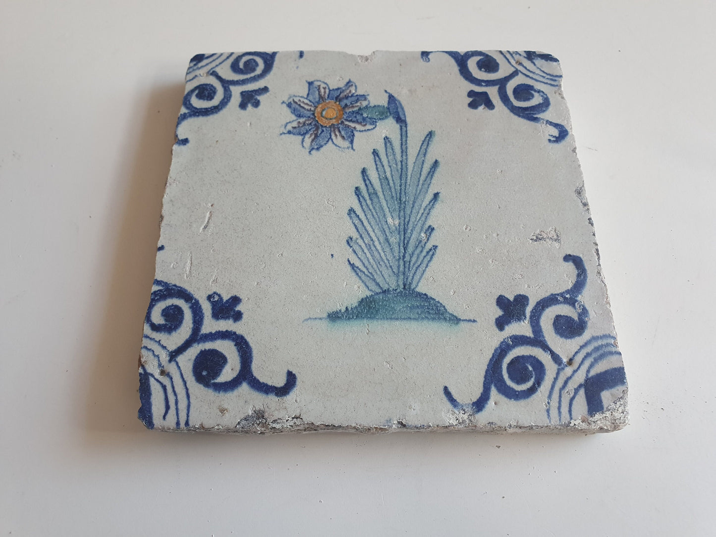 Antique Delft Tile – Polychrome Flower, Oxhead Motifs (circa 1640)