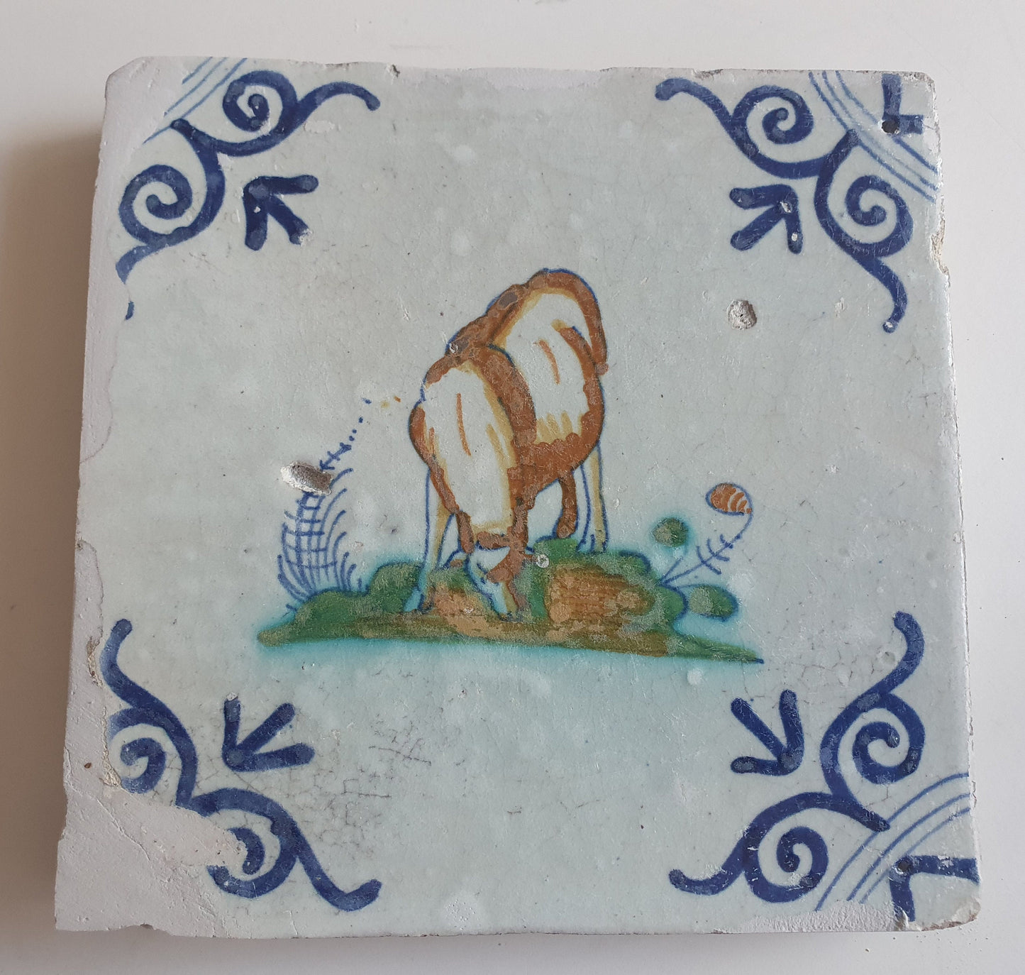 Antique Dutch Delft Tile – Sheep Motif, Polychrome Oxhead Corner, 17th Century