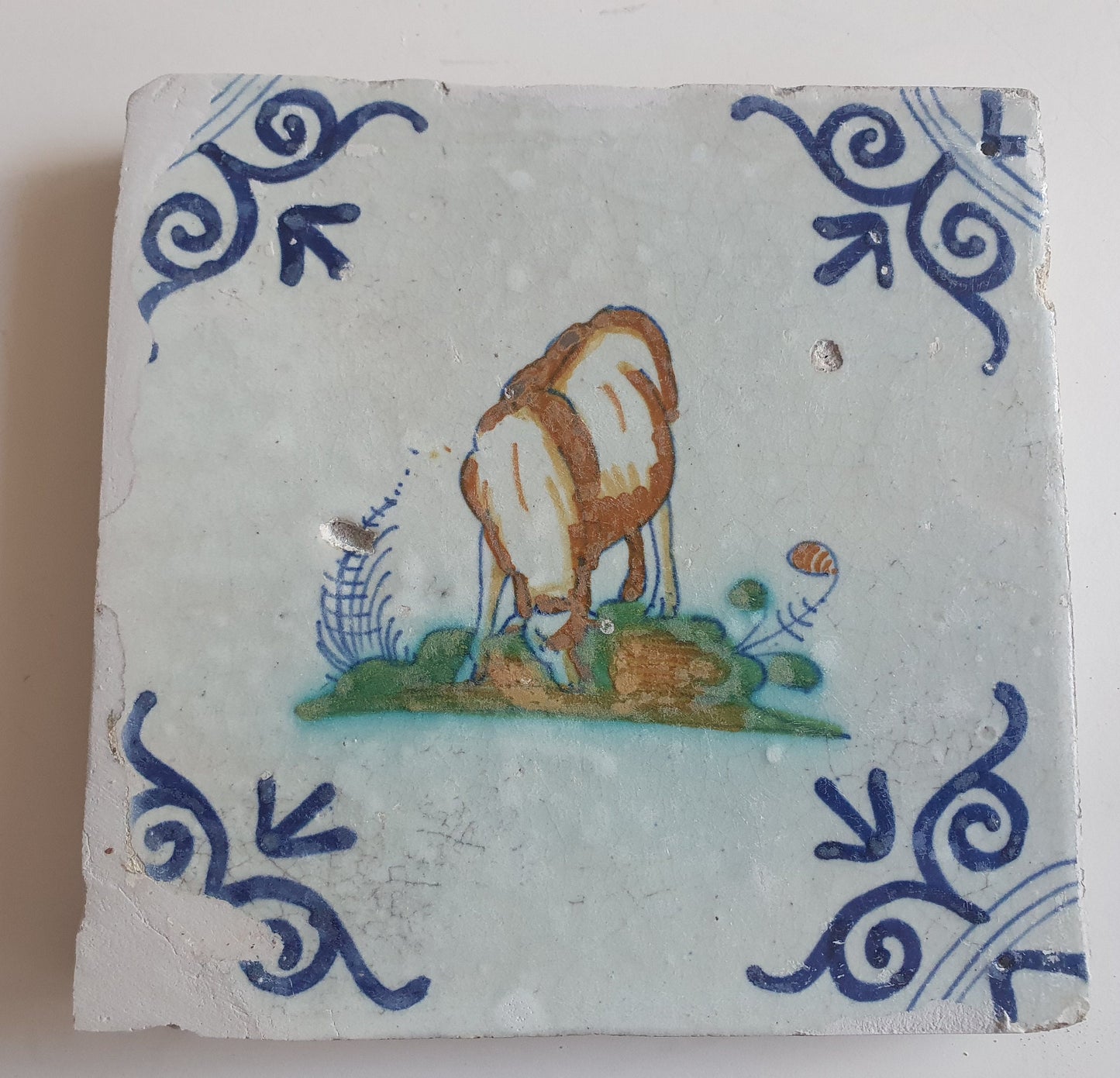 Antique Dutch Delft Tile – Sheep Motif, Polychrome Oxhead Corner, 17th Century