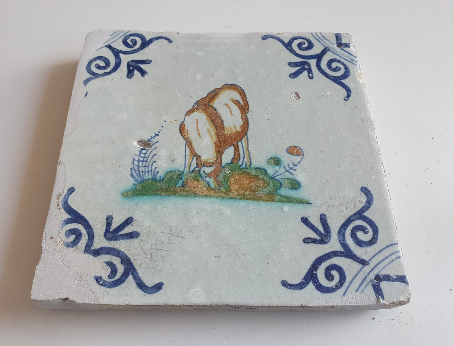 Antique Dutch Delft Tile – Sheep Motif, Polychrome Oxhead Corner, 17th Century