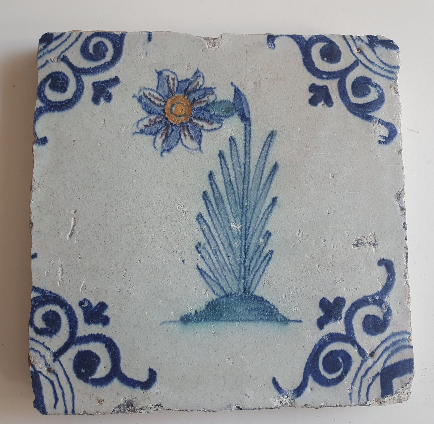Antique Delft Tile – Polychrome Flower, Oxhead Motifs (circa 1640)
