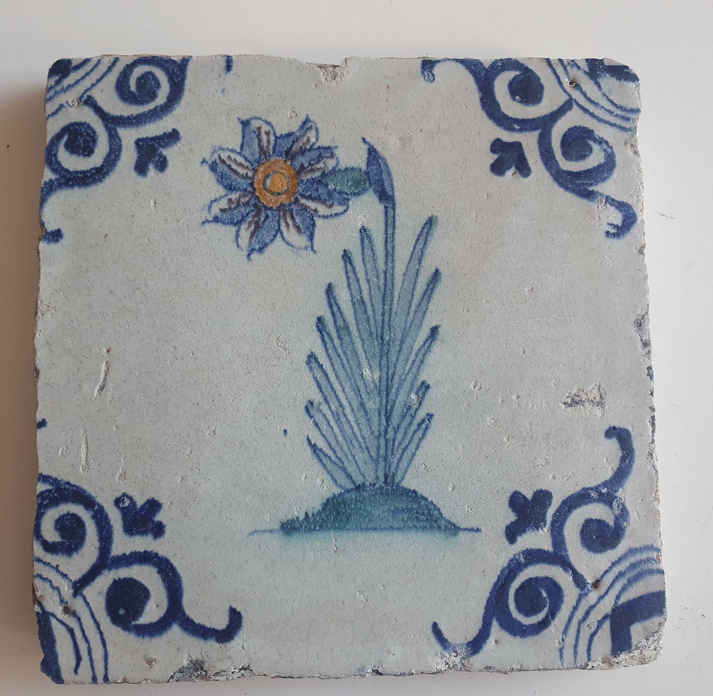Antique Delft Tile – Polychrome Flower, Oxhead Motifs (circa 1640)