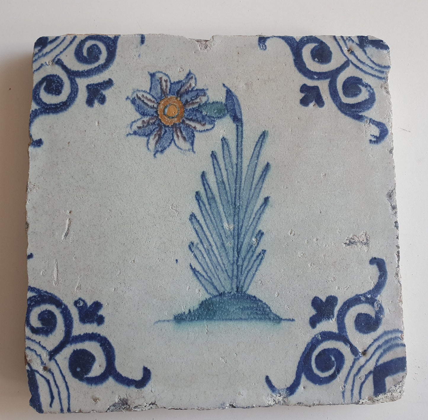 Antique Delft Tile – Polychrome Flower, Oxhead Motifs (circa 1640)