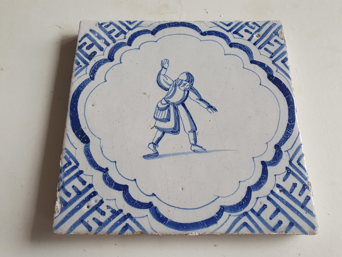 Antique Dutch Delft Blue Tile - representation of a dancer with a meander shape - Dated around 1640