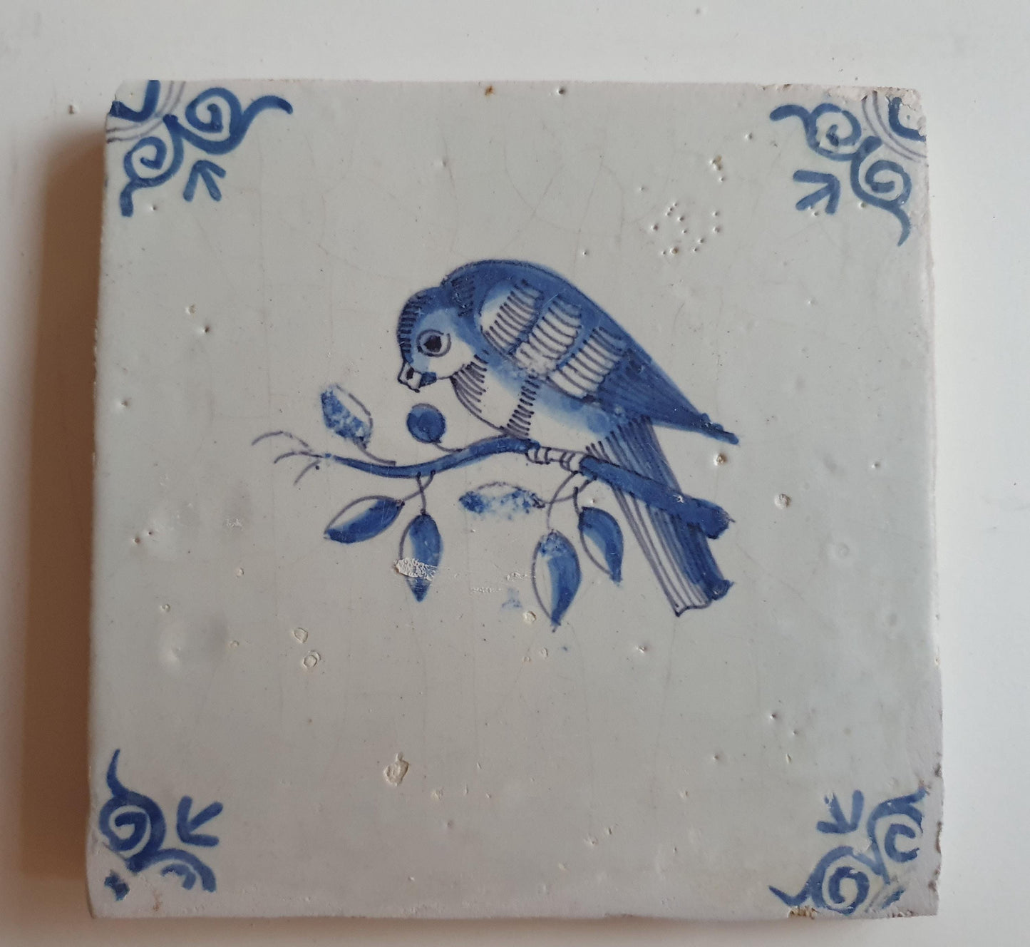 17th century Antique Dutch Tile bird with oxhead corner motive delft blue holland tile
