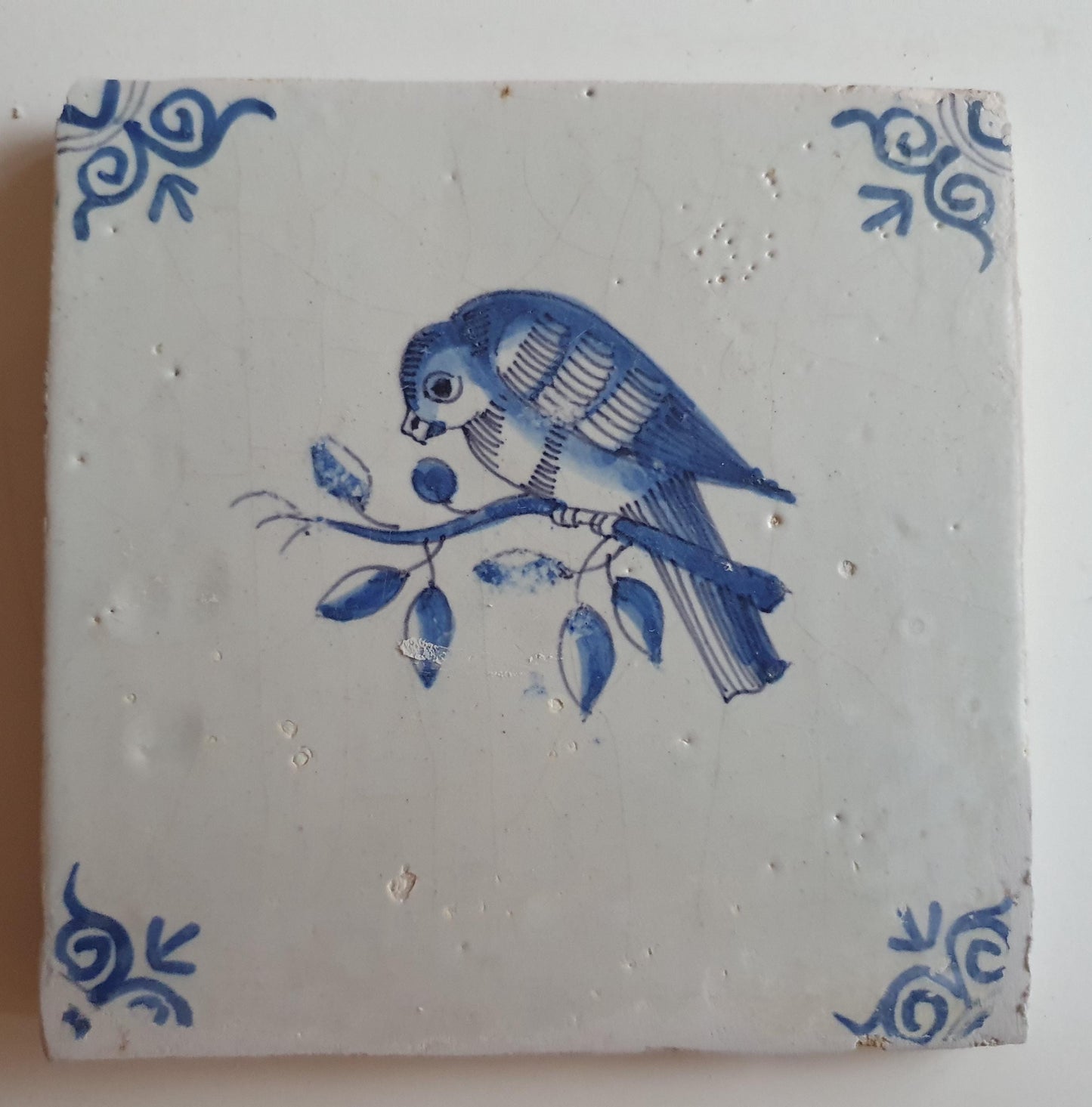 17th century Antique Dutch Tile bird with oxhead corner motive delft blue holland tile