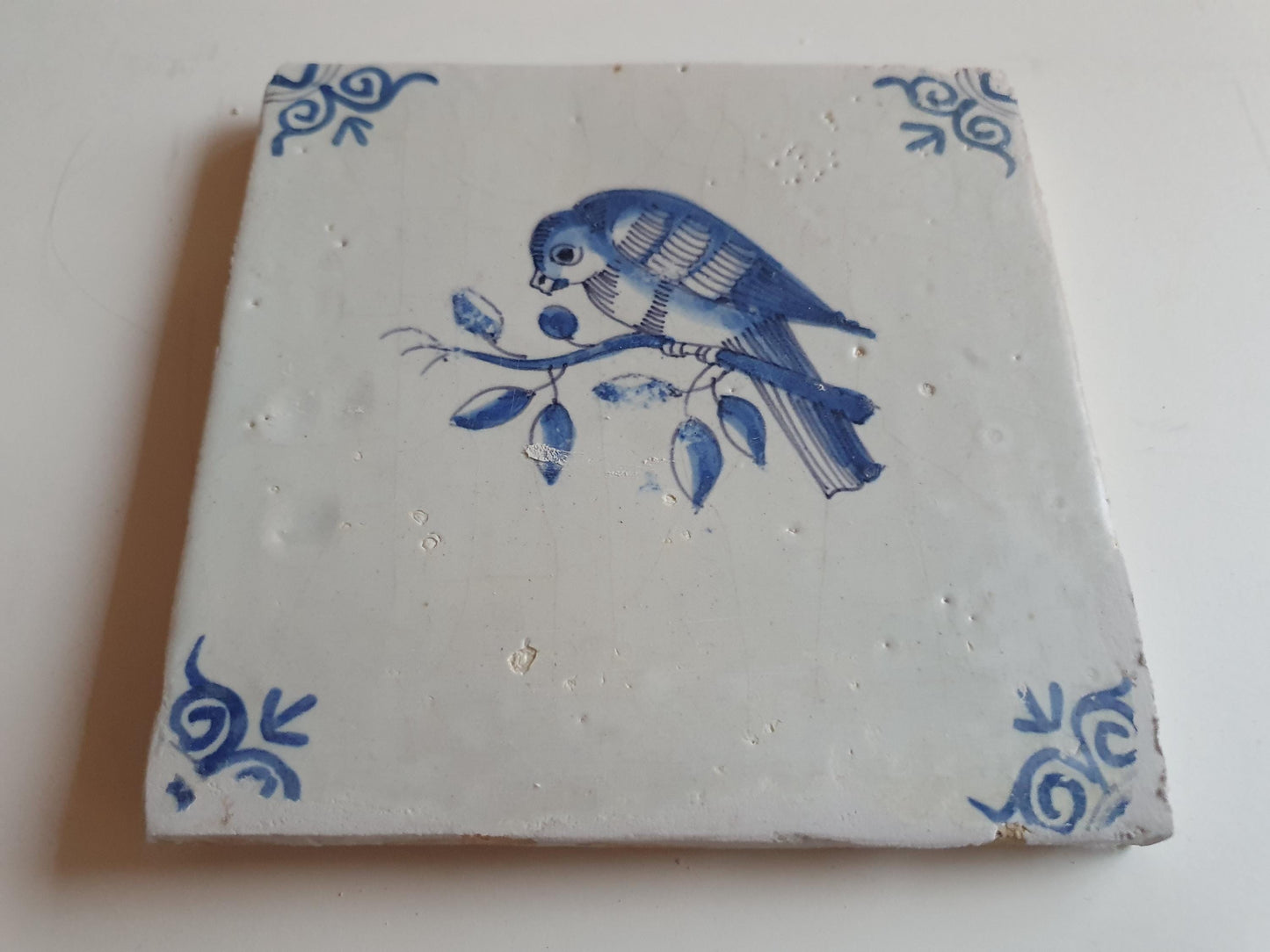 17th century Antique Dutch Tile bird with oxhead corner motive delft blue holland tile