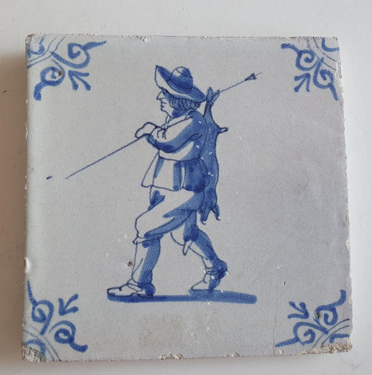 Dutch antique tile, 17th century, hunter with hare on his back, oxhead corner Rare !