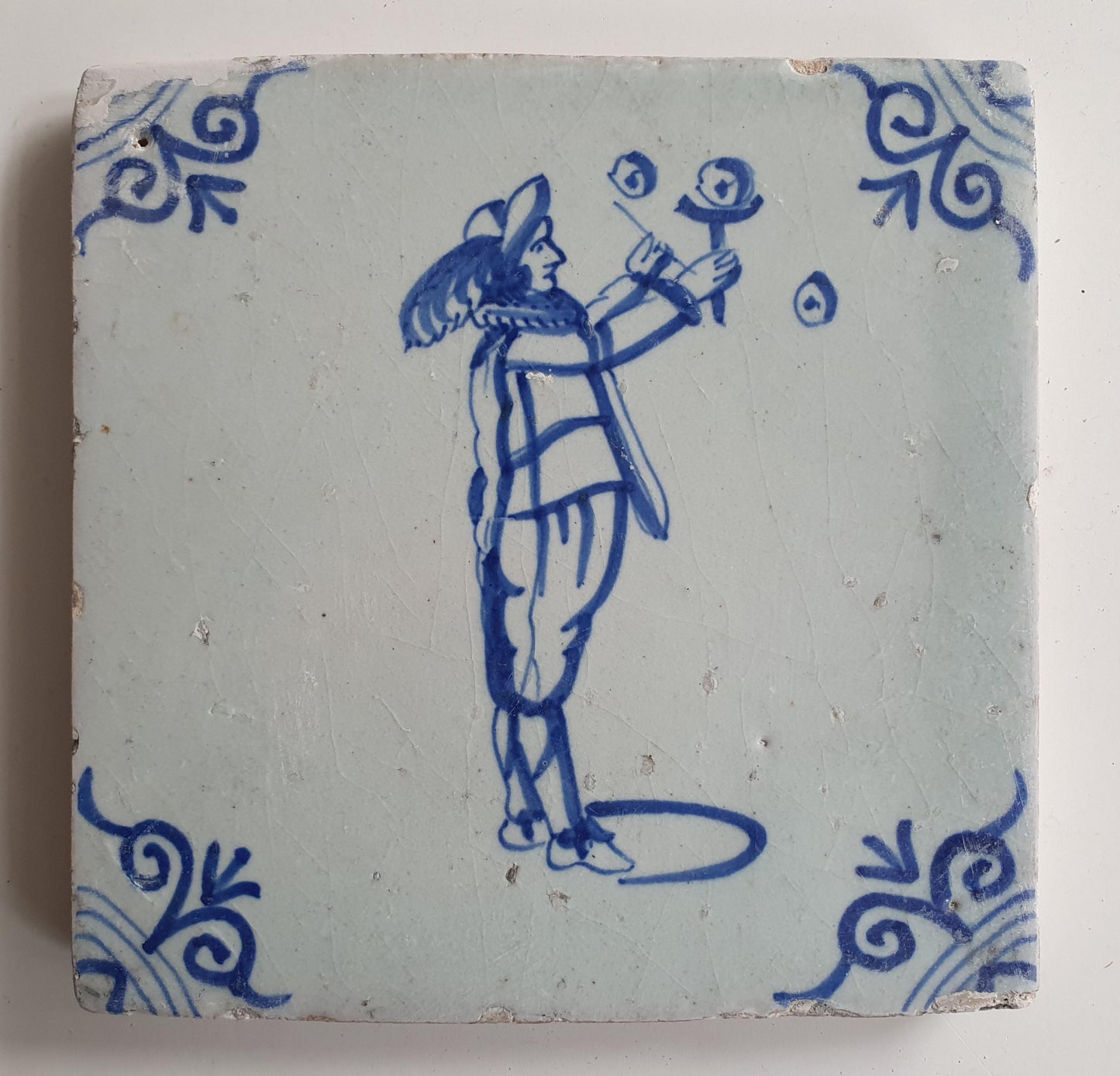 17th Century Delft Tile: Child Blowing Bubbles, Blue Ox-Head Motif