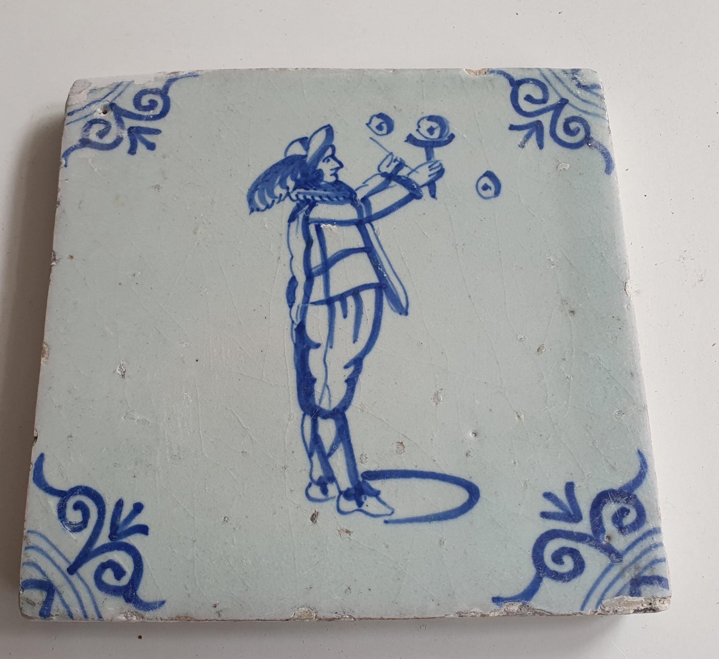 17th Century Delft Tile: Child Blowing Bubbles, Blue Ox-Head Motif
