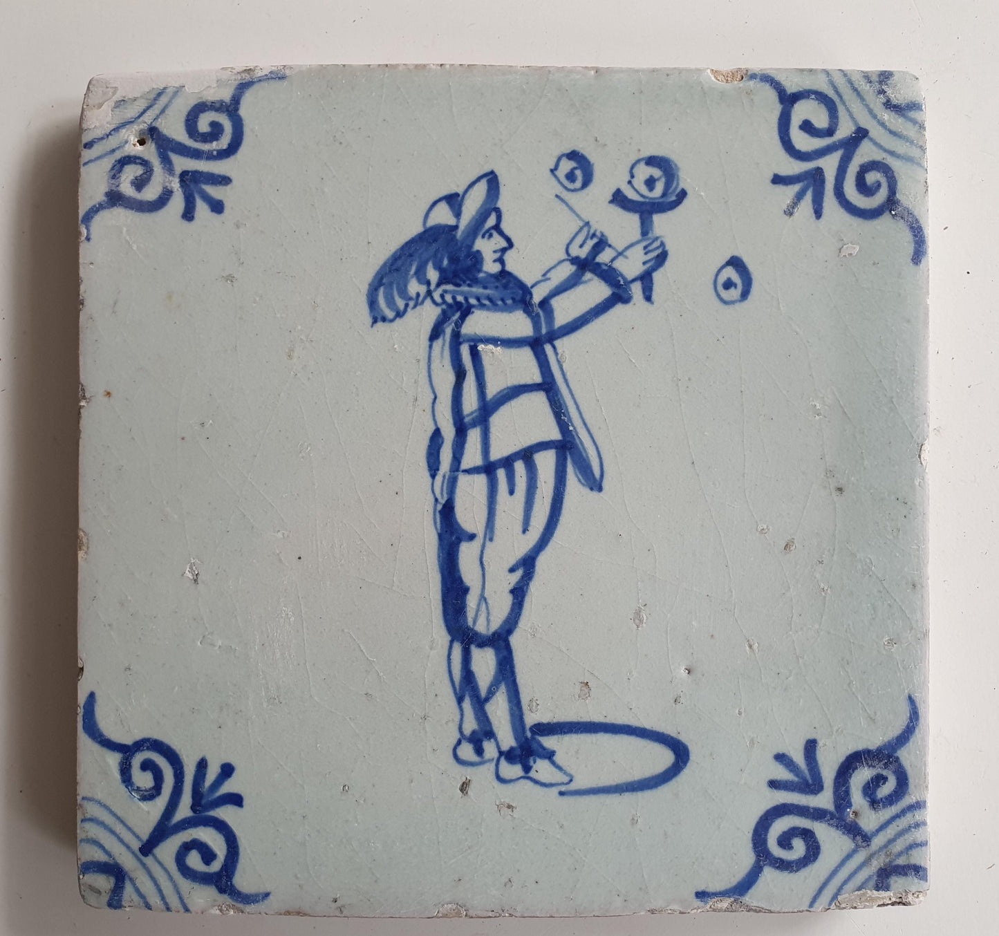 17th Century Delft Tile: Child Blowing Bubbles, Blue Ox-Head Motif