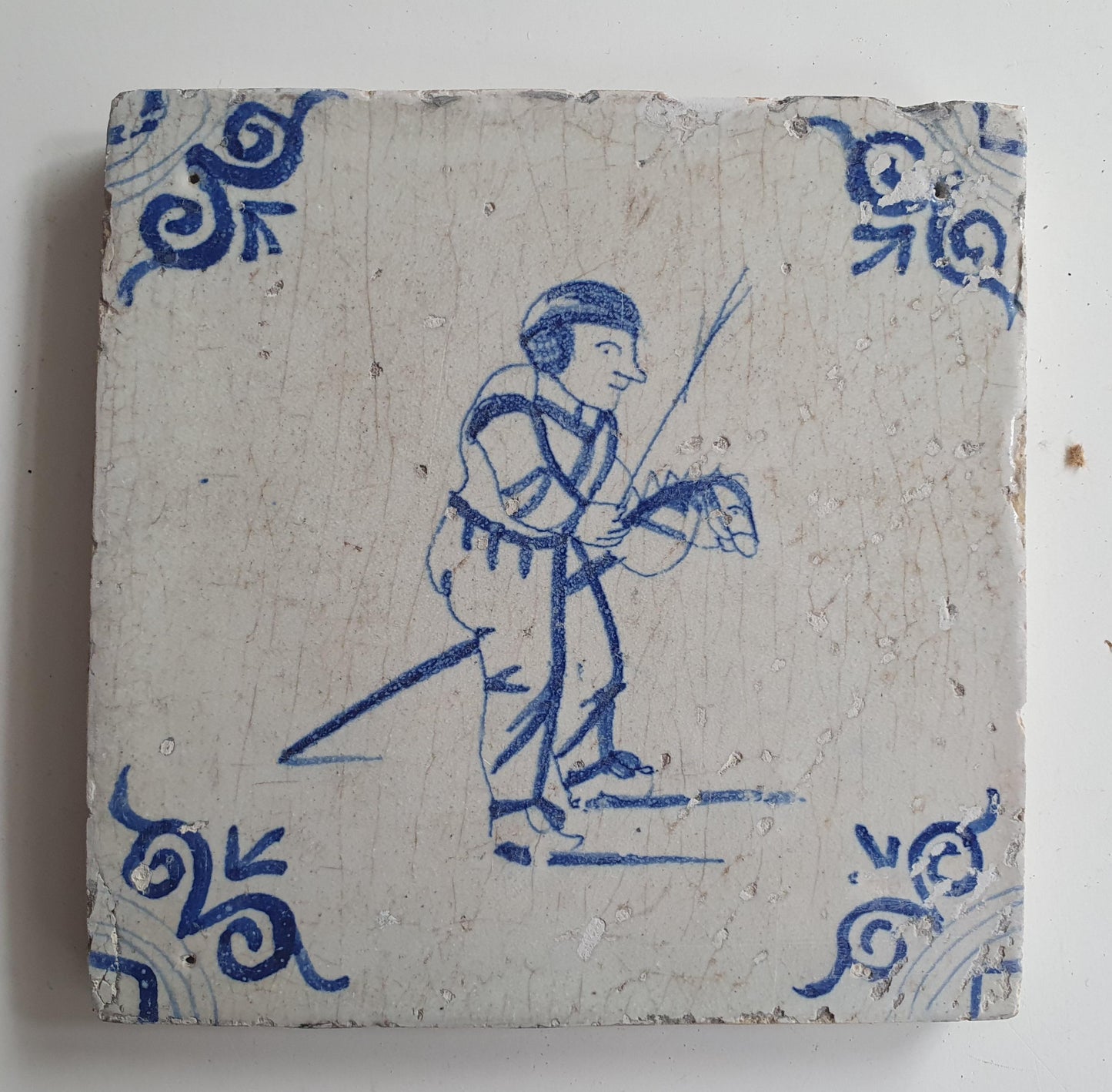 17th Delft tile was  made around 1650 and depicts a  child with a  stick horse