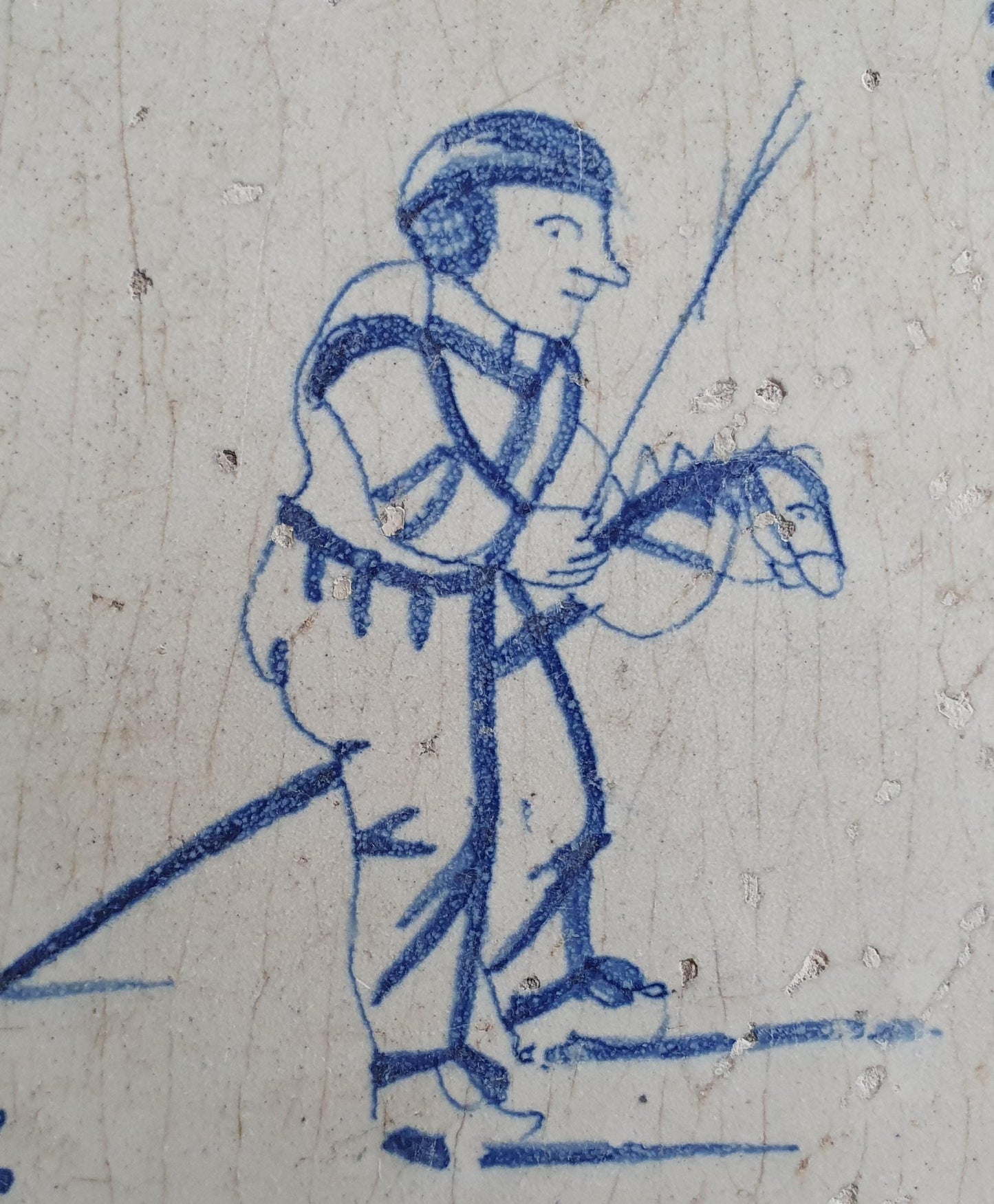 17th Delft tile was  made around 1650 and depicts a  child with a  stick horse