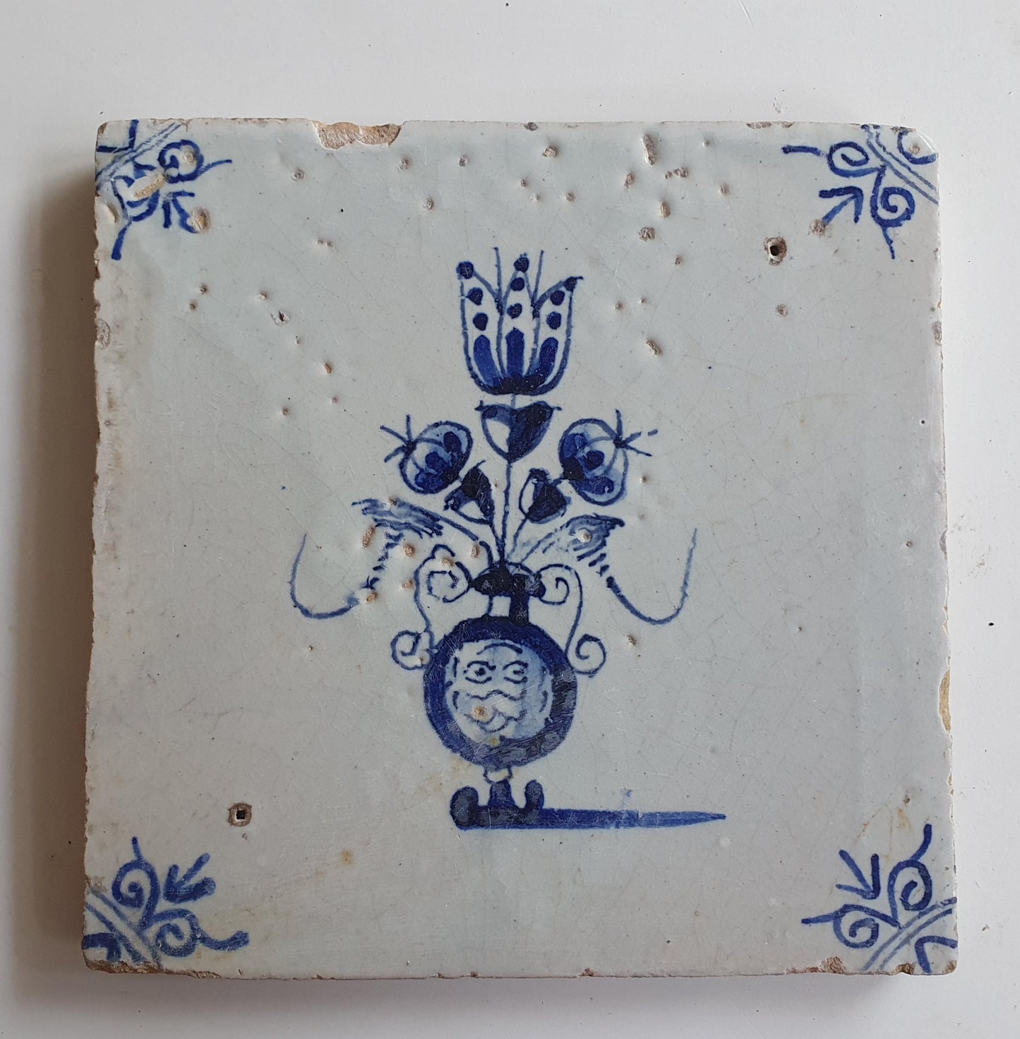 17th century Antique Dutch Tile flower with oxhead corner motive delft blue holland tile