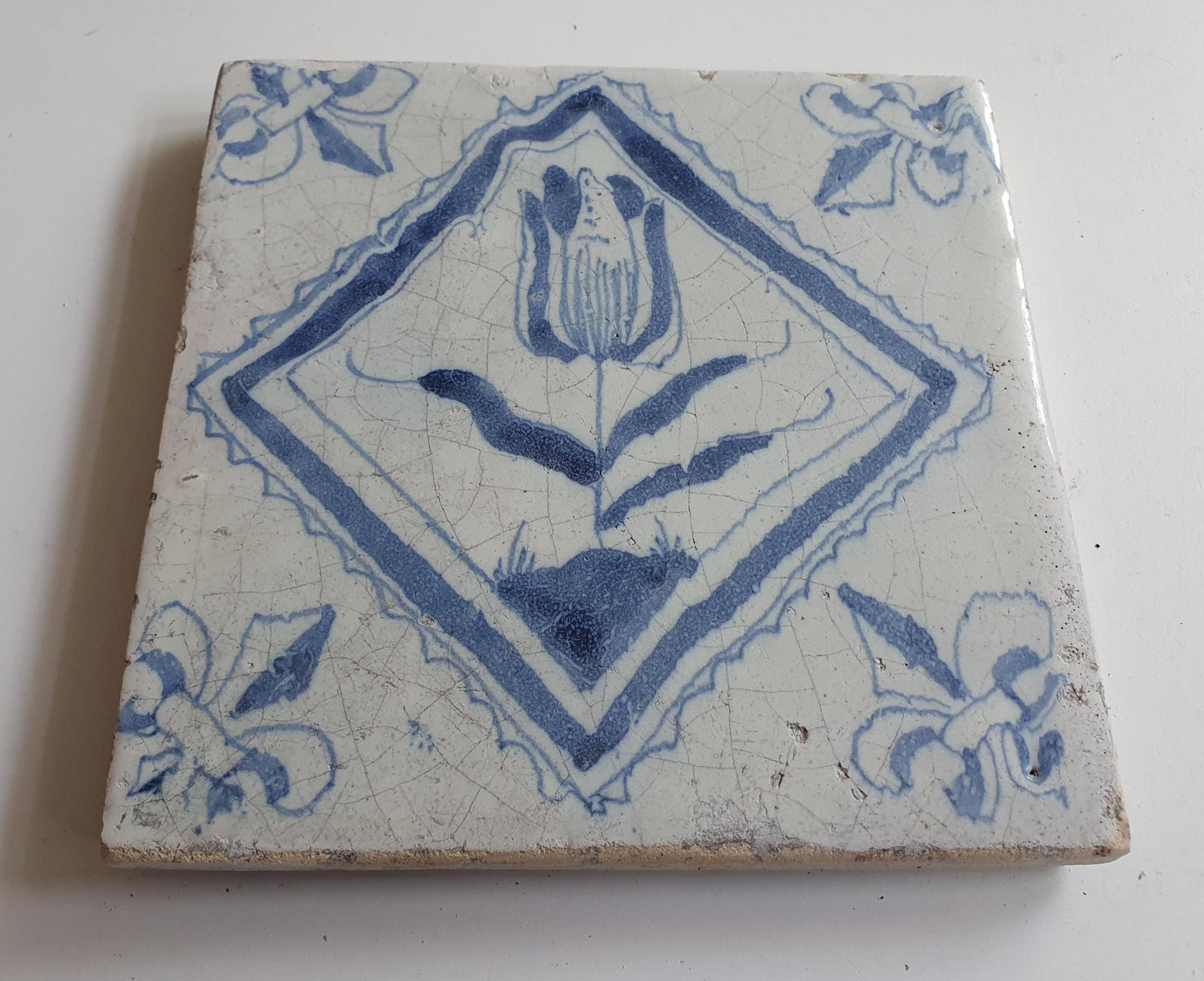 17th century Antique Dutch Tile flower with lilyhead corner motive delft blue holland tile
