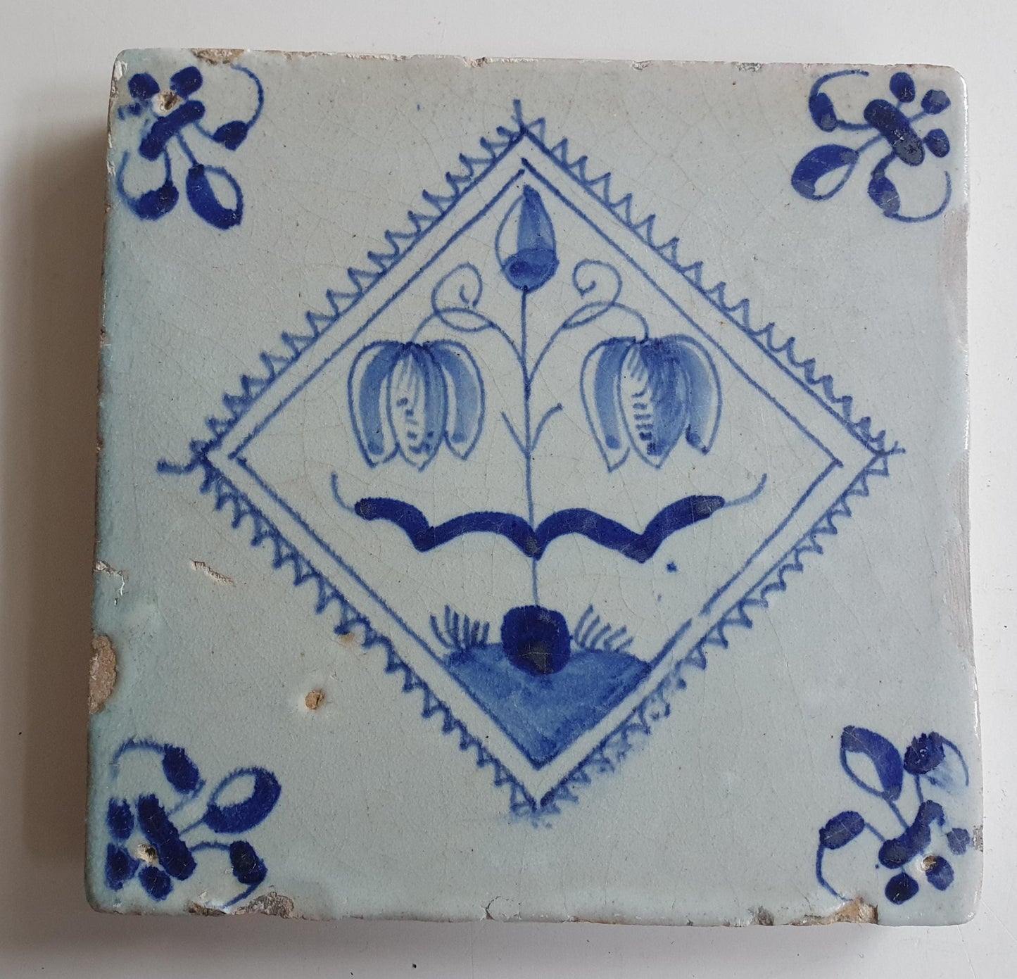 17th century Antique Dutch Tile flower with lilyhead corner motive delft blue holland tile