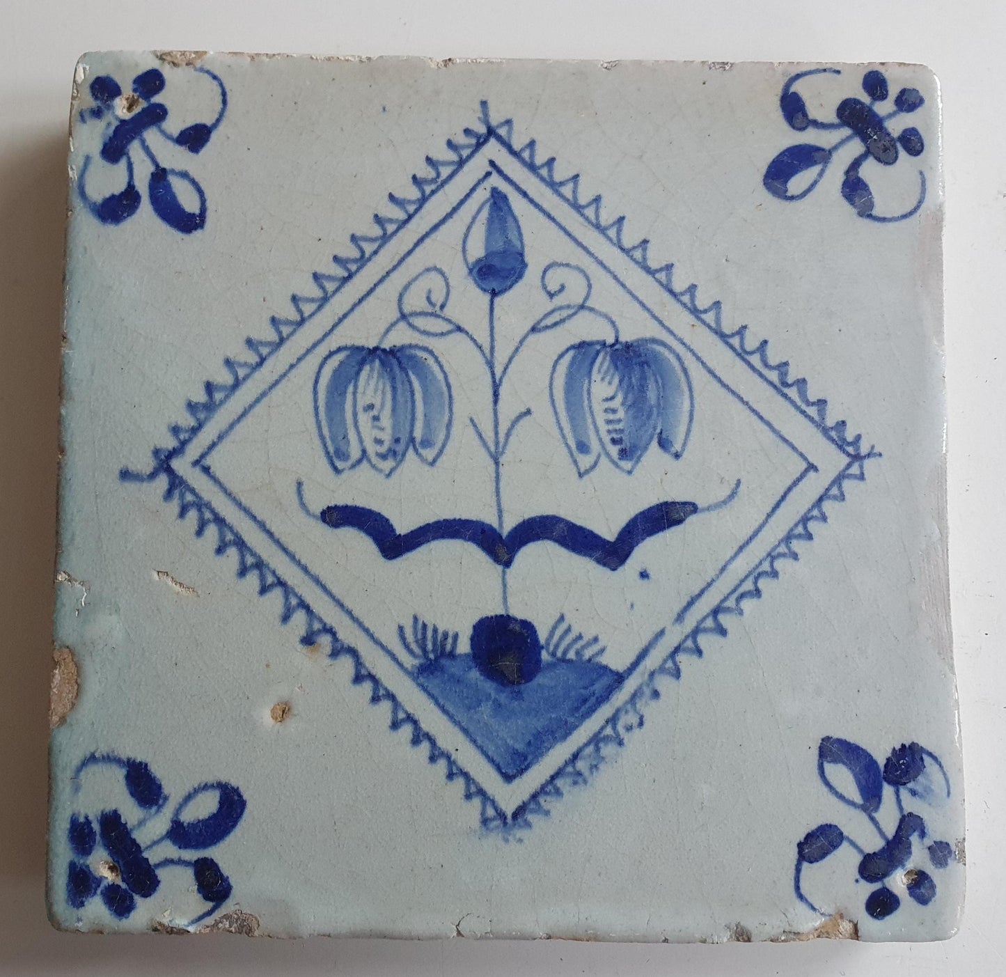 17th century Antique Dutch Tile flower with lilyhead corner motive delft blue holland tile