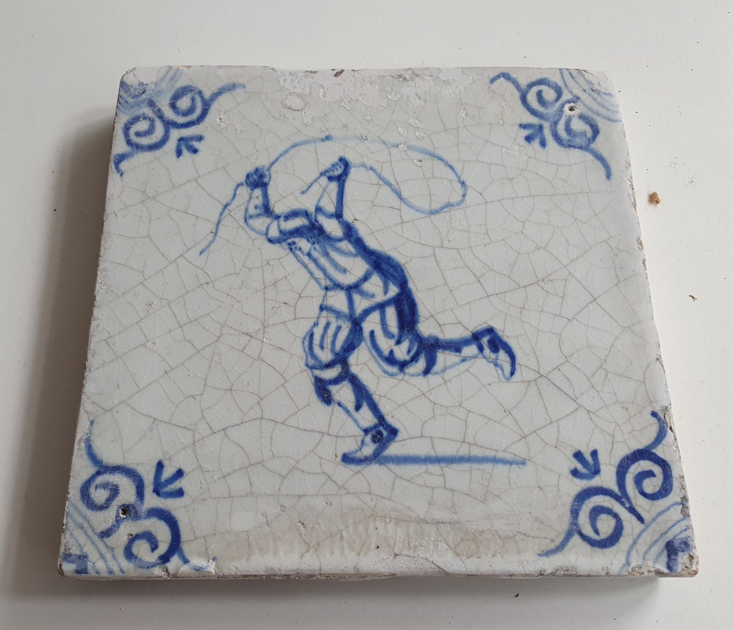 17th Delft tile was  made around 1650 and depicts a  child with a jumping rope.