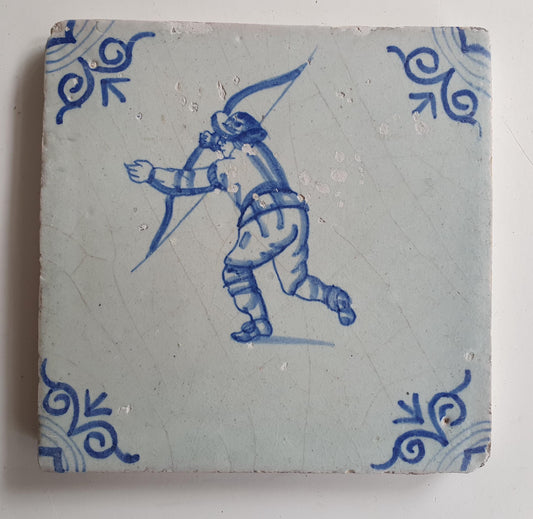 17th Delft tile was  made around 1650 and depicts a  child with a bow and arrow.