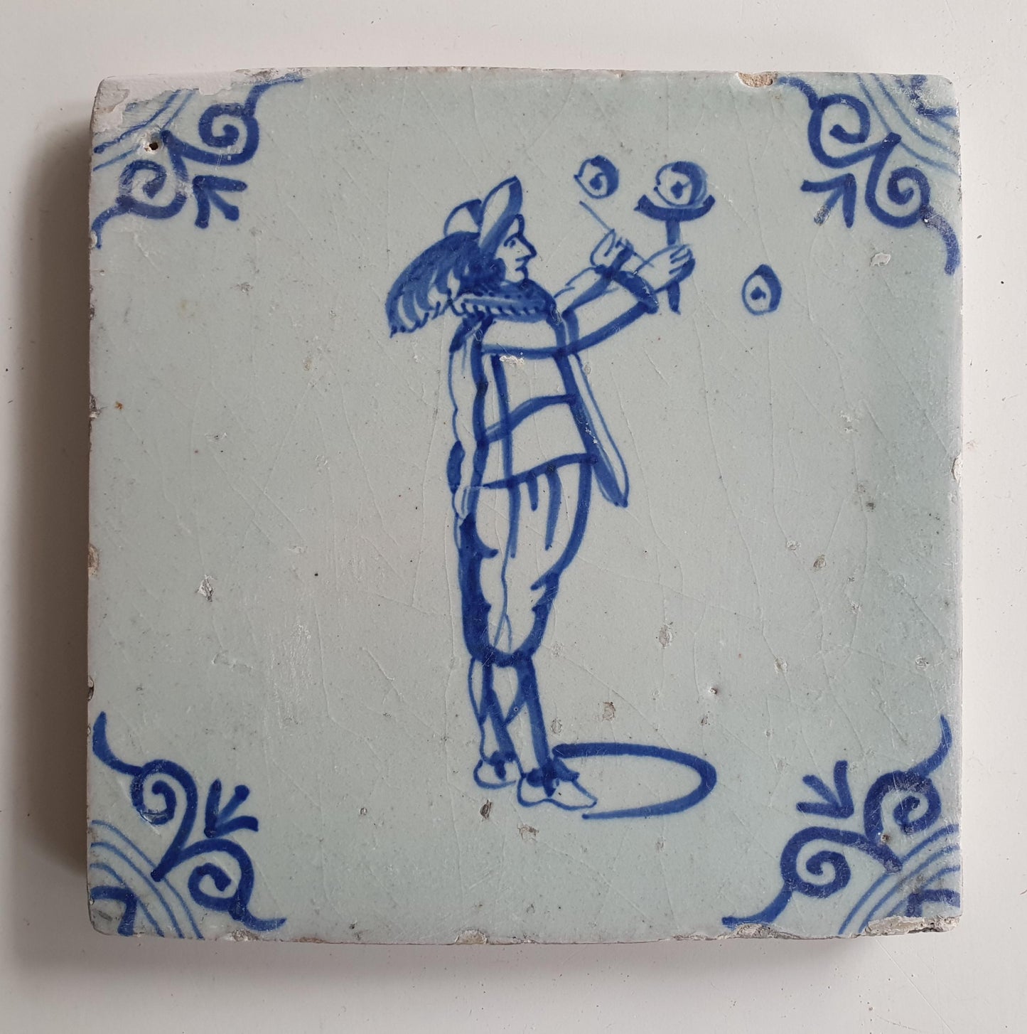 17th Century Delft Tile: Child Blowing Bubbles, Blue Ox-Head Motif