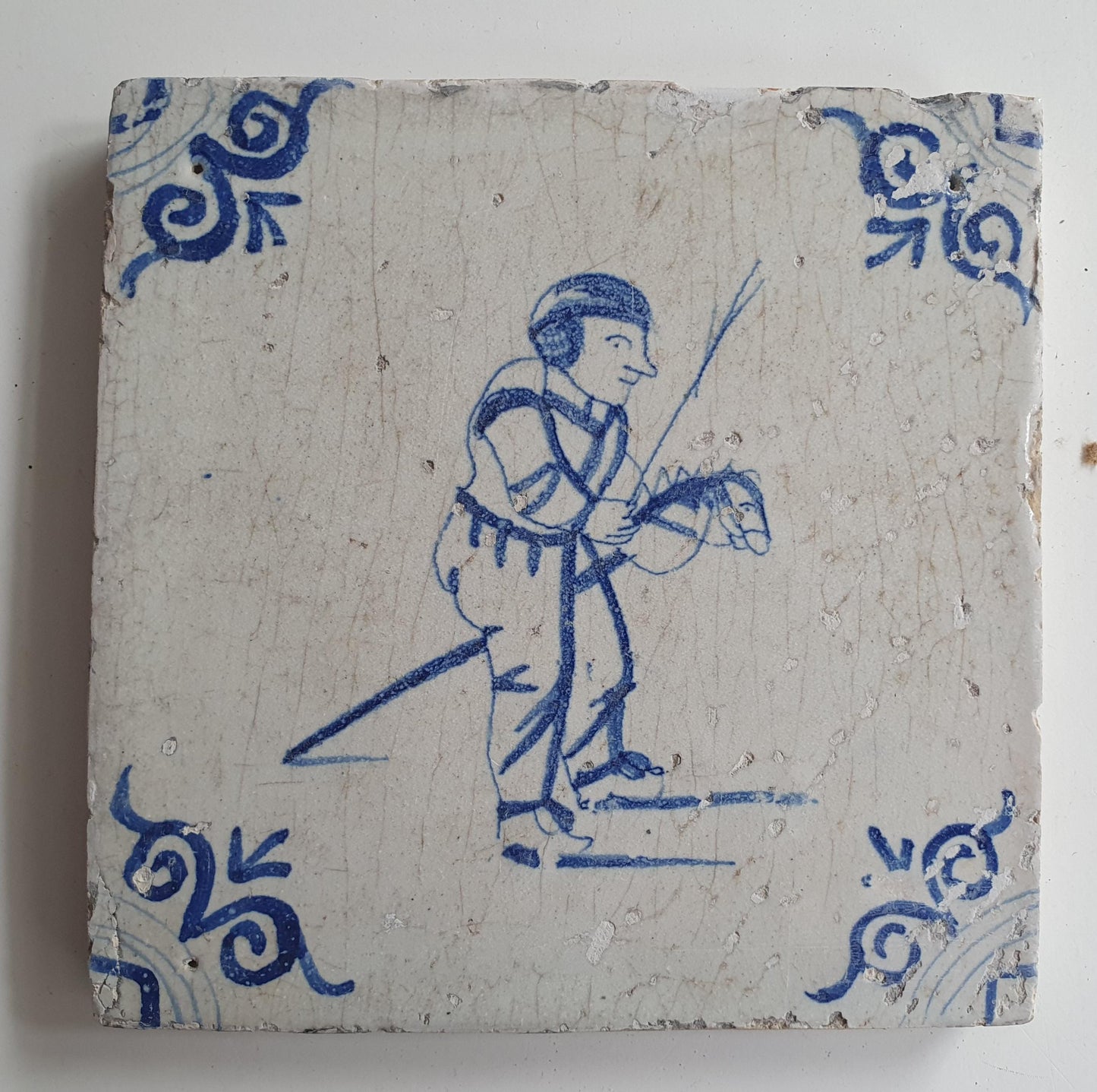 17th Delft tile was  made around 1650 and depicts a  child with a  stick horse