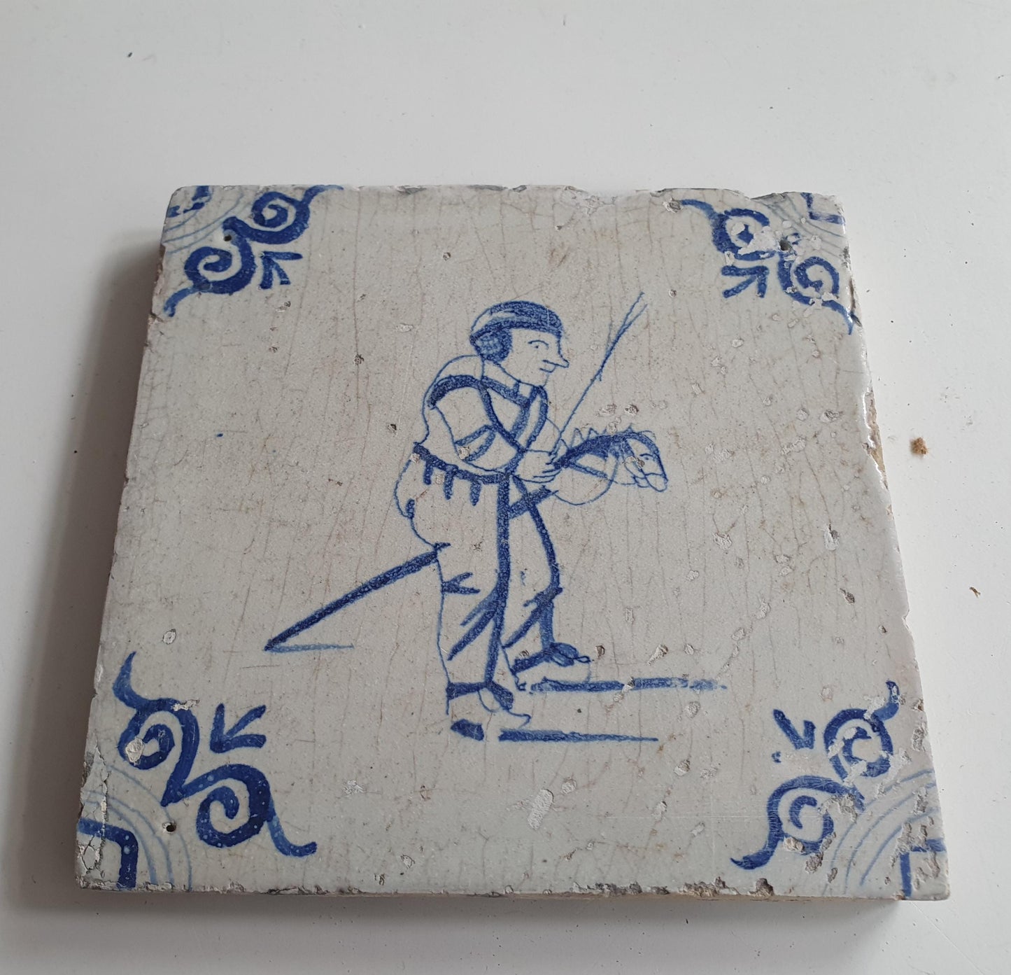17th Delft tile was  made around 1650 and depicts a  child with a  stick horse