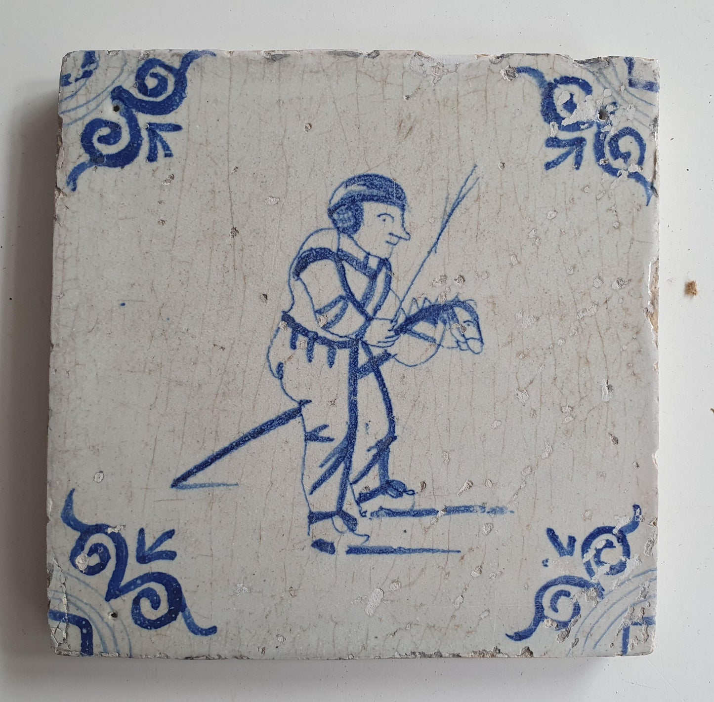 17th Delft tile was  made around 1650 and depicts a  child with a  stick horse