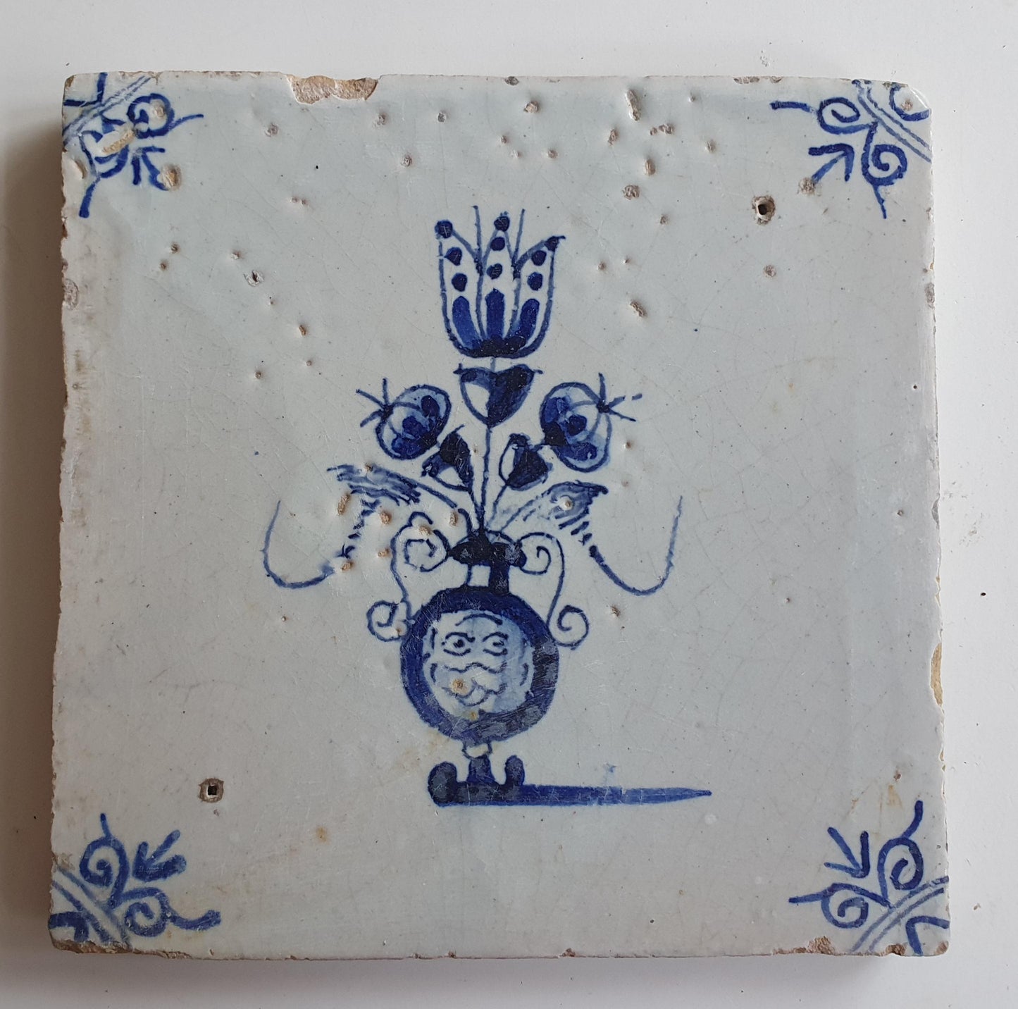 17th century Antique Dutch Tile flower with oxhead corner motive delft blue holland tile