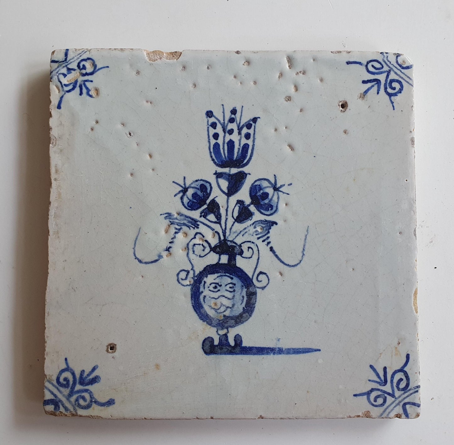 17th century Antique Dutch Tile flower with oxhead corner motive delft blue holland tile