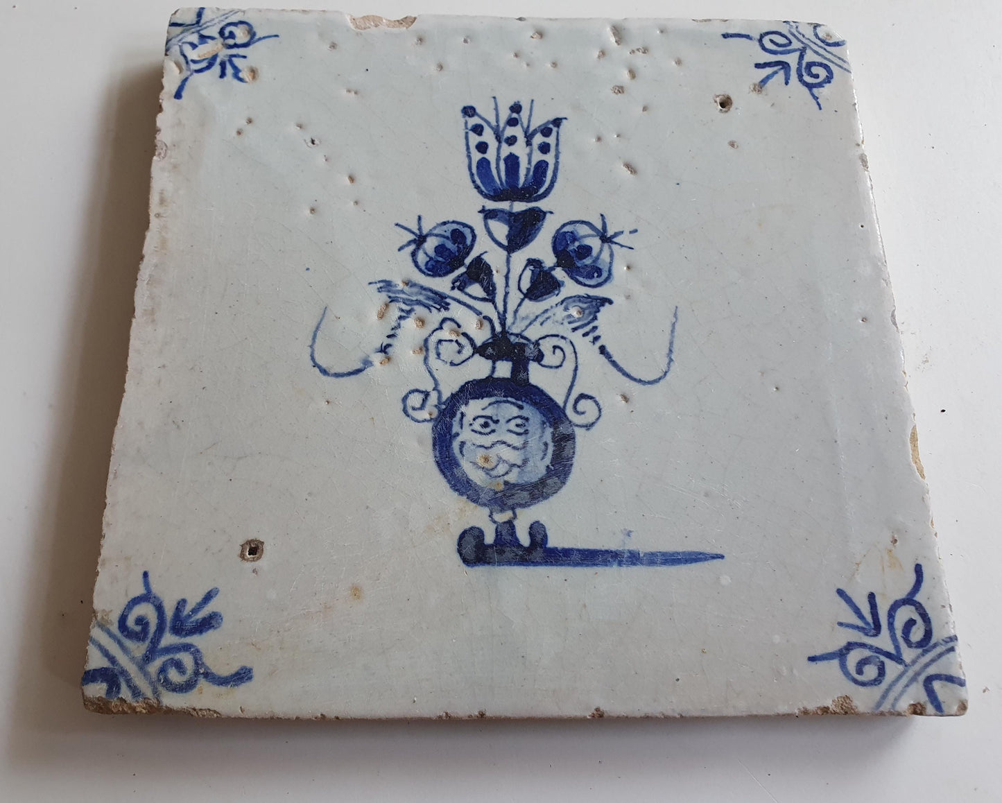 17th century Antique Dutch Tile flower with oxhead corner motive delft blue holland tile