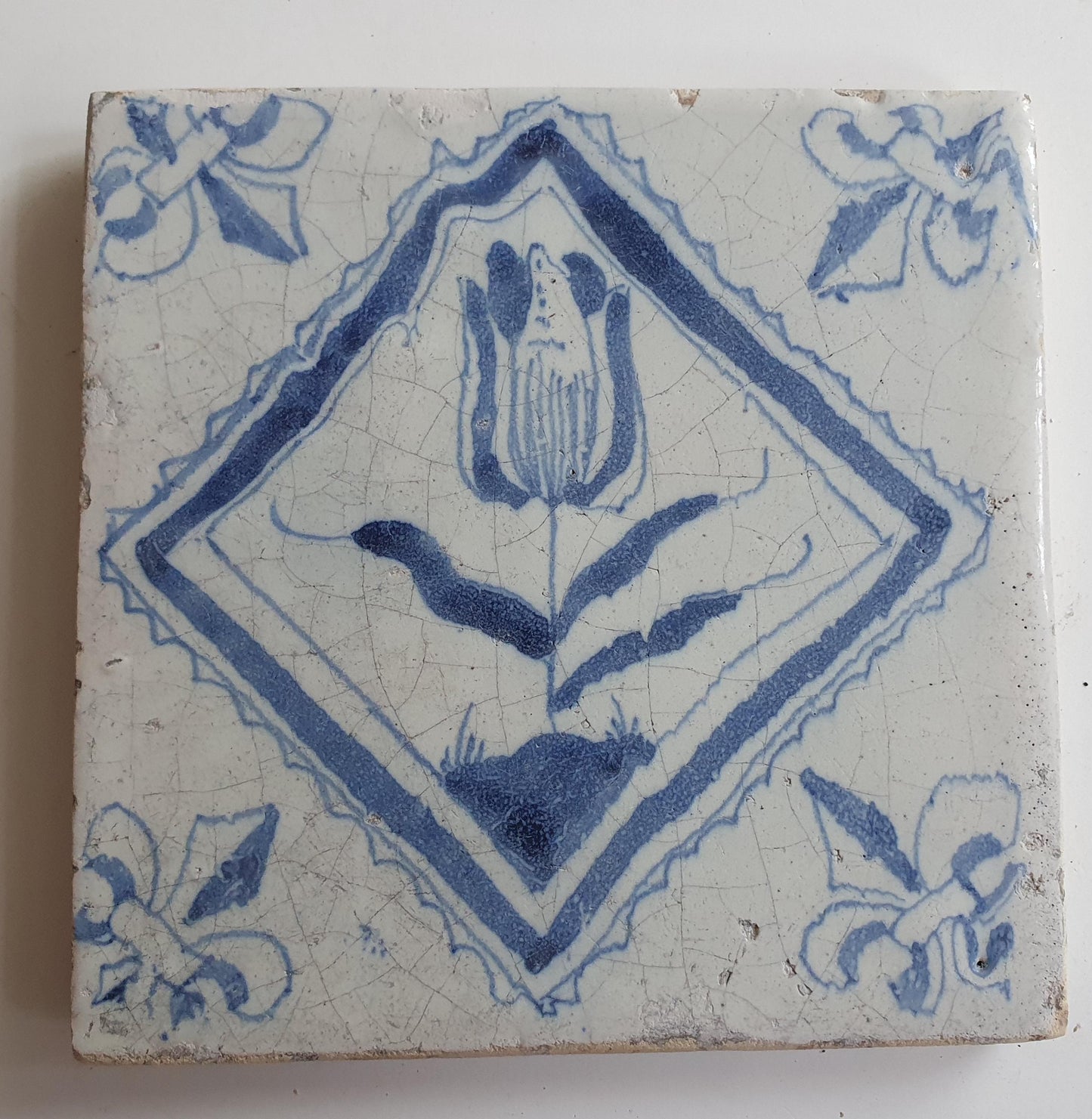 17th century Antique Dutch Tile flower with lilyhead corner motive delft blue holland tile