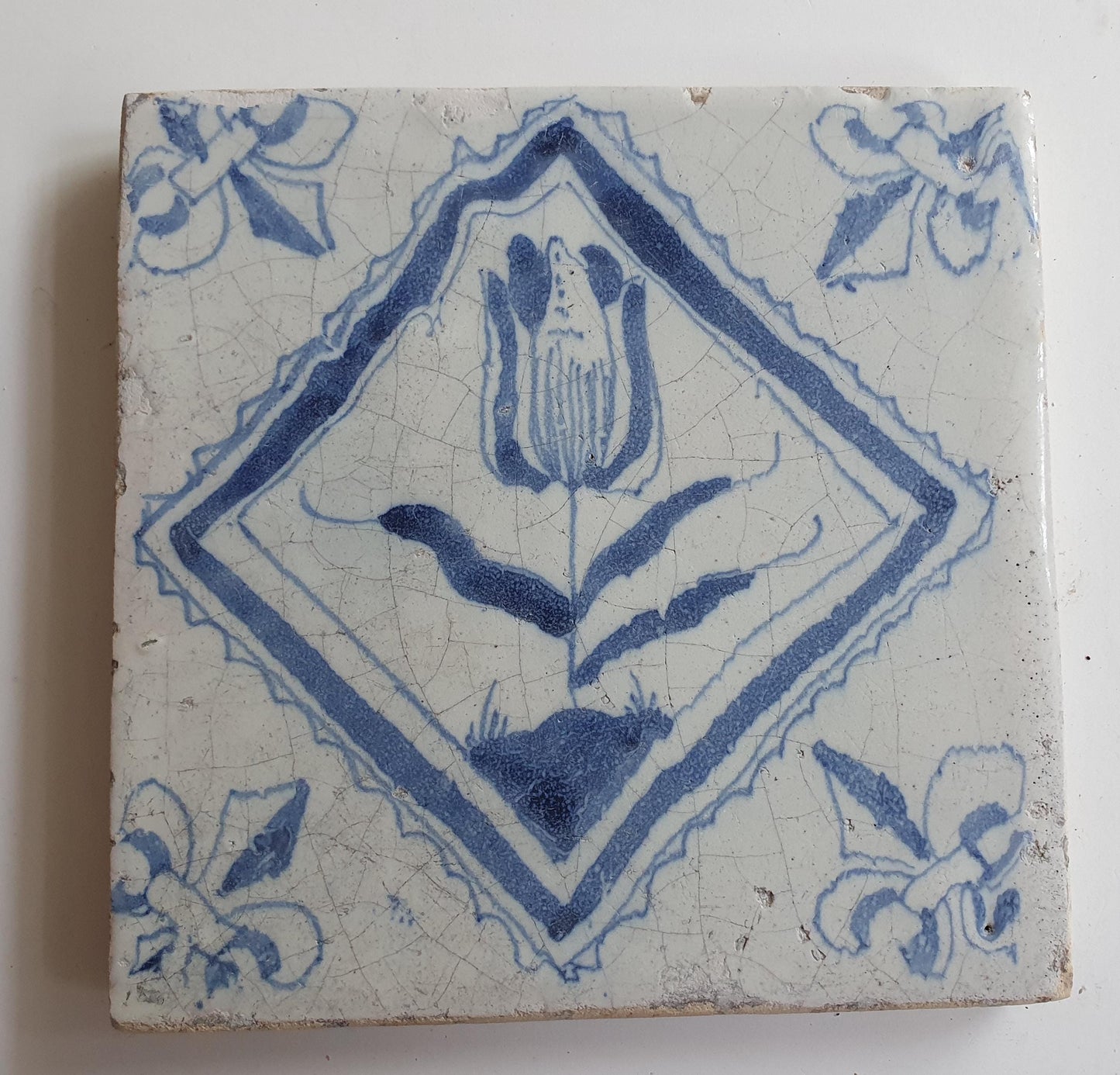 17th century Antique Dutch Tile flower with lilyhead corner motive delft blue holland tile