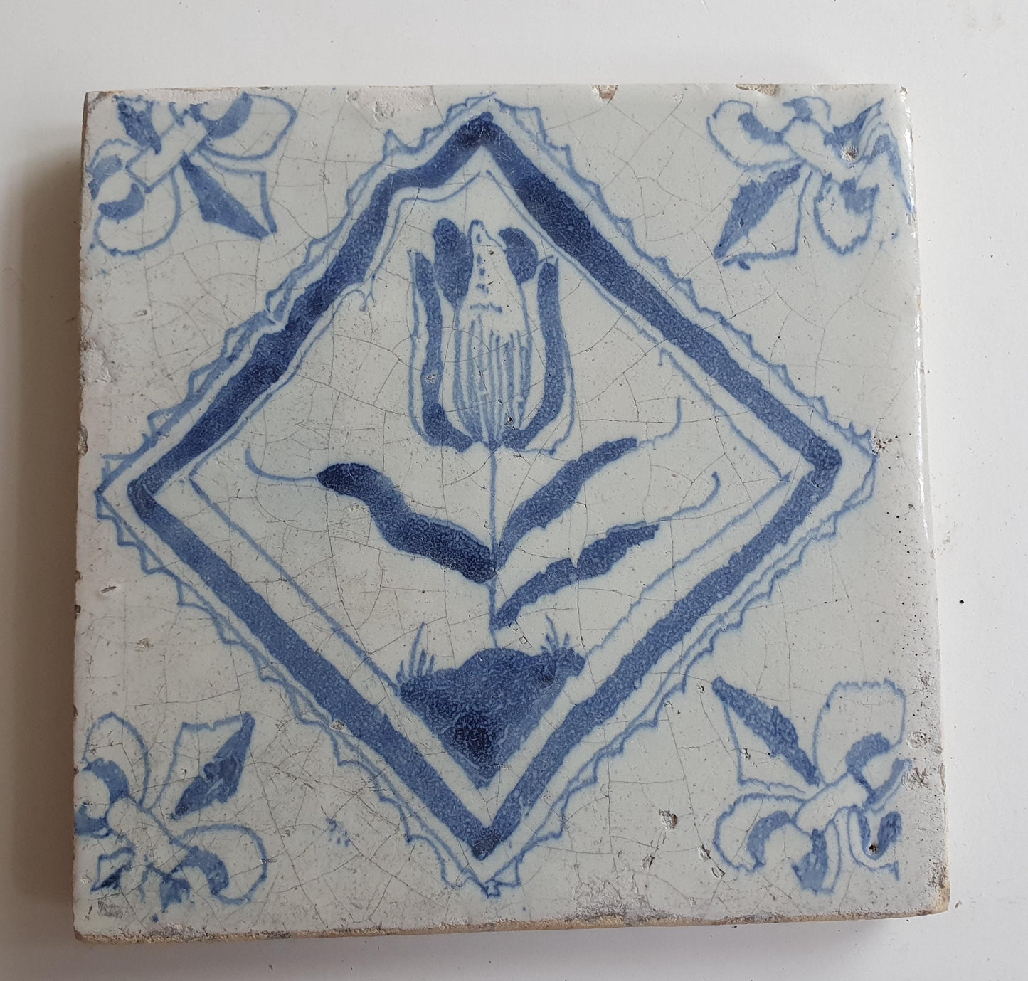 17th century Antique Dutch Tile flower with lilyhead corner motive delft blue holland tile
