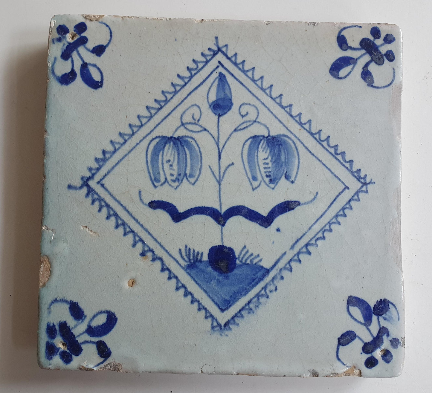 17th century Antique Dutch Tile flower with lilyhead corner motive delft blue holland tile