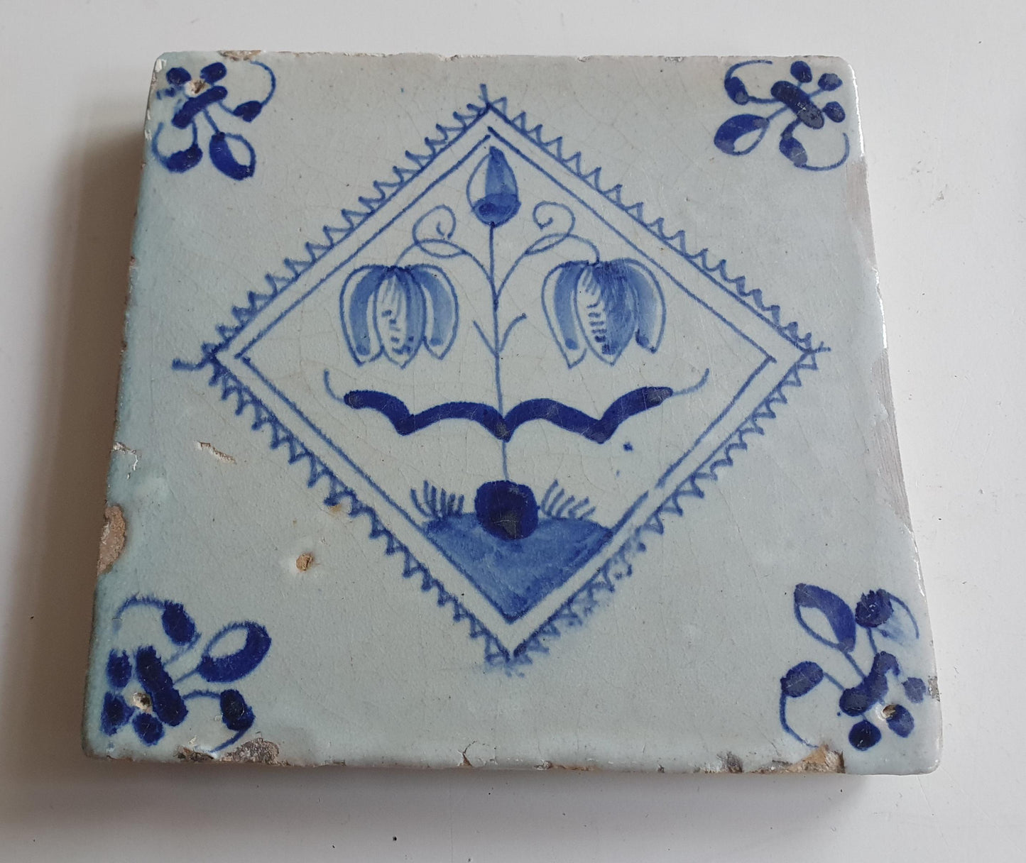 17th century Antique Dutch Tile flower with lilyhead corner motive delft blue holland tile