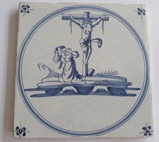 This original 18th century (c. 1740) Delft tile depicts the crucifixtion of Jesus Christ.
