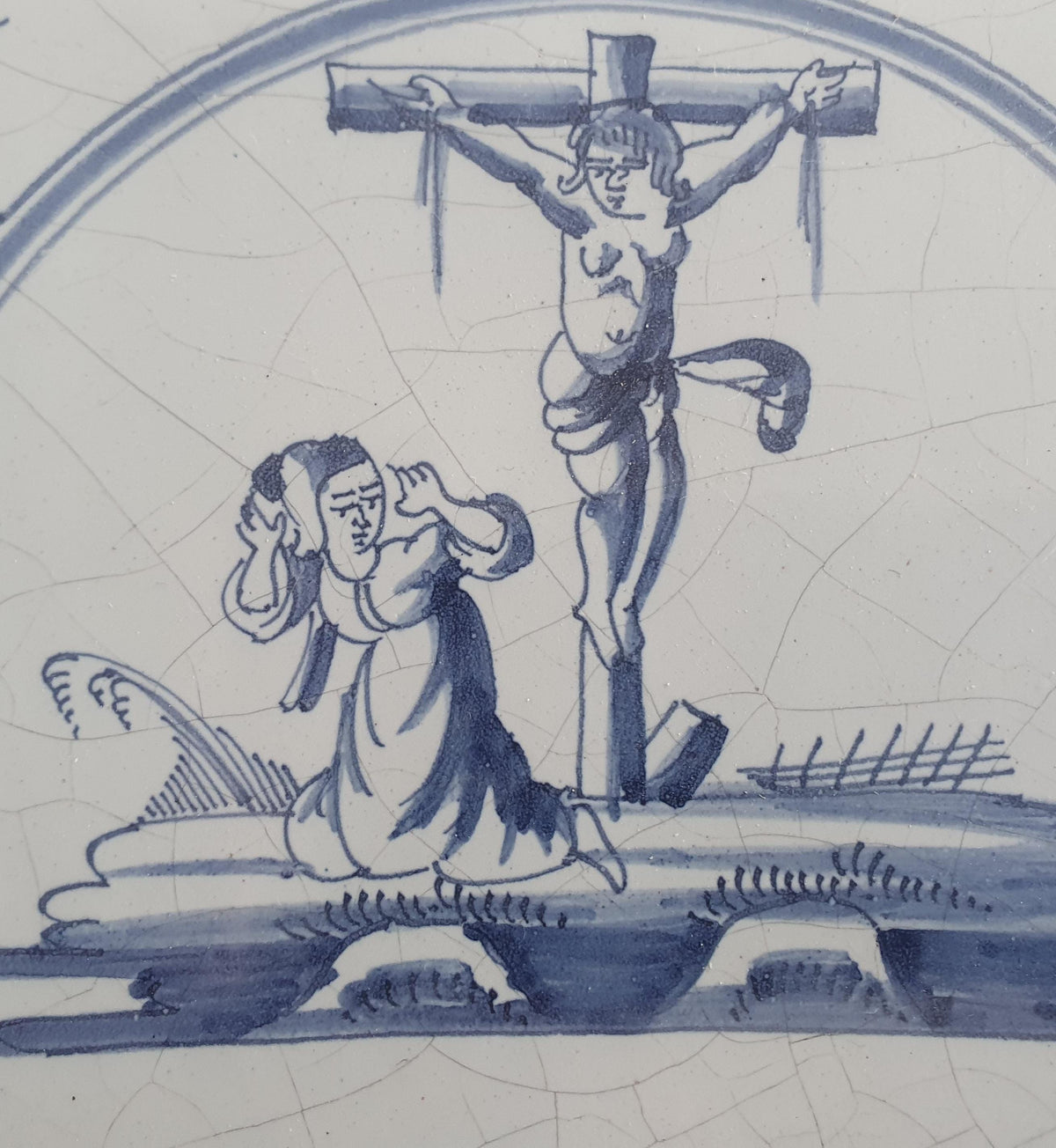 This original 18th century (c. 1740) Delft tile depicts the crucifixtion of Jesus Christ.